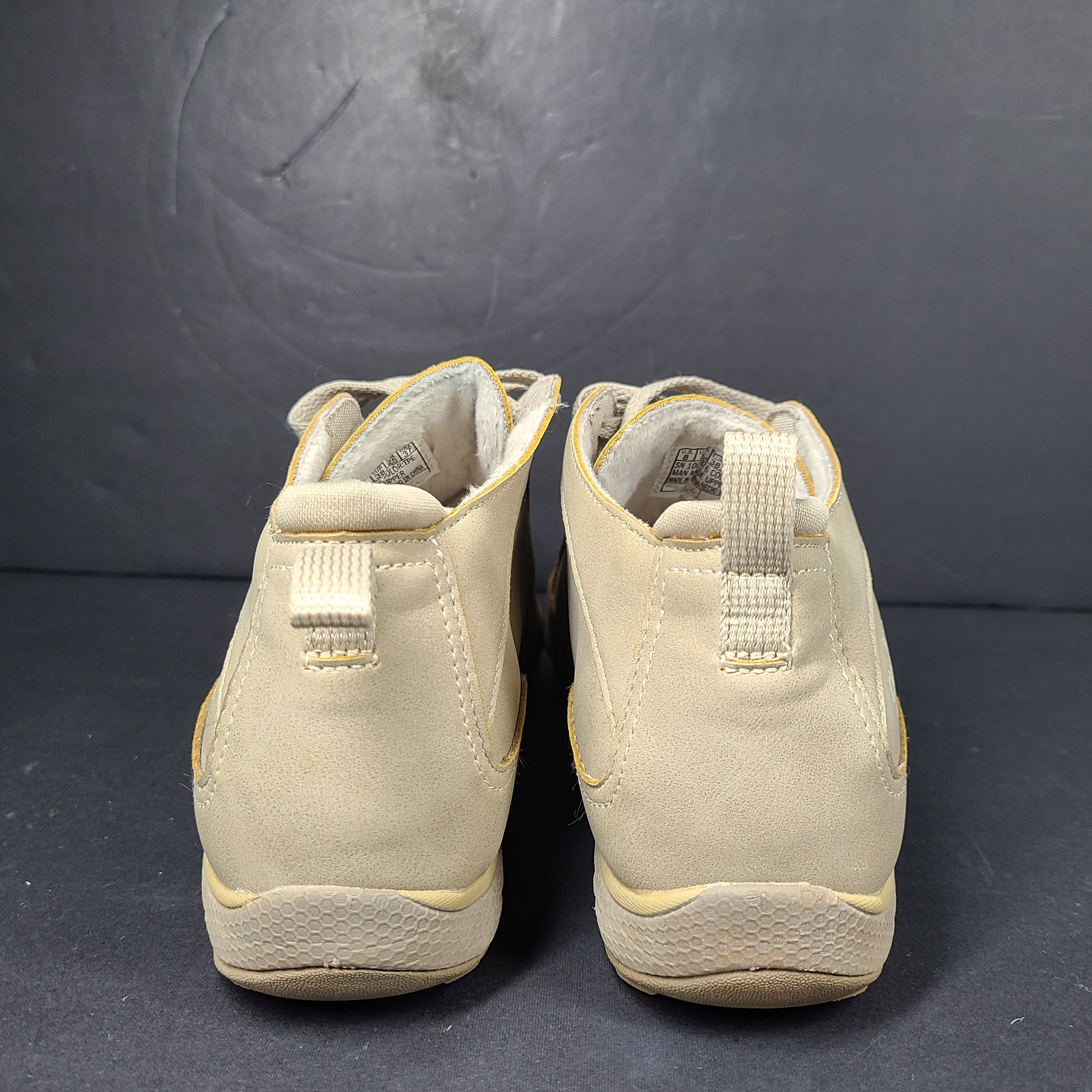 A pair of beige Skechers women's sneakers with a relaxed fit design.