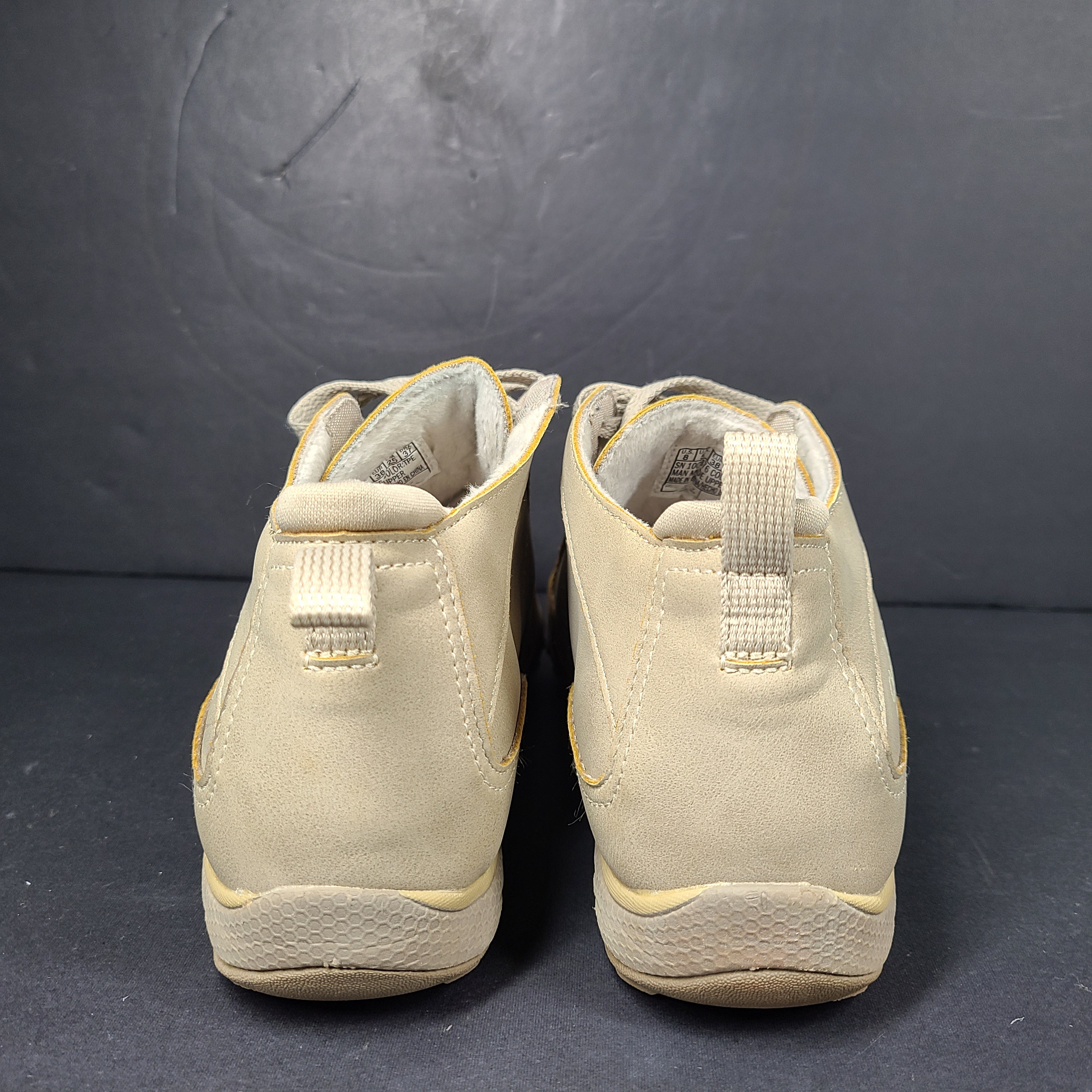 A pair of beige Skechers women's sneakers with a relaxed fit design.