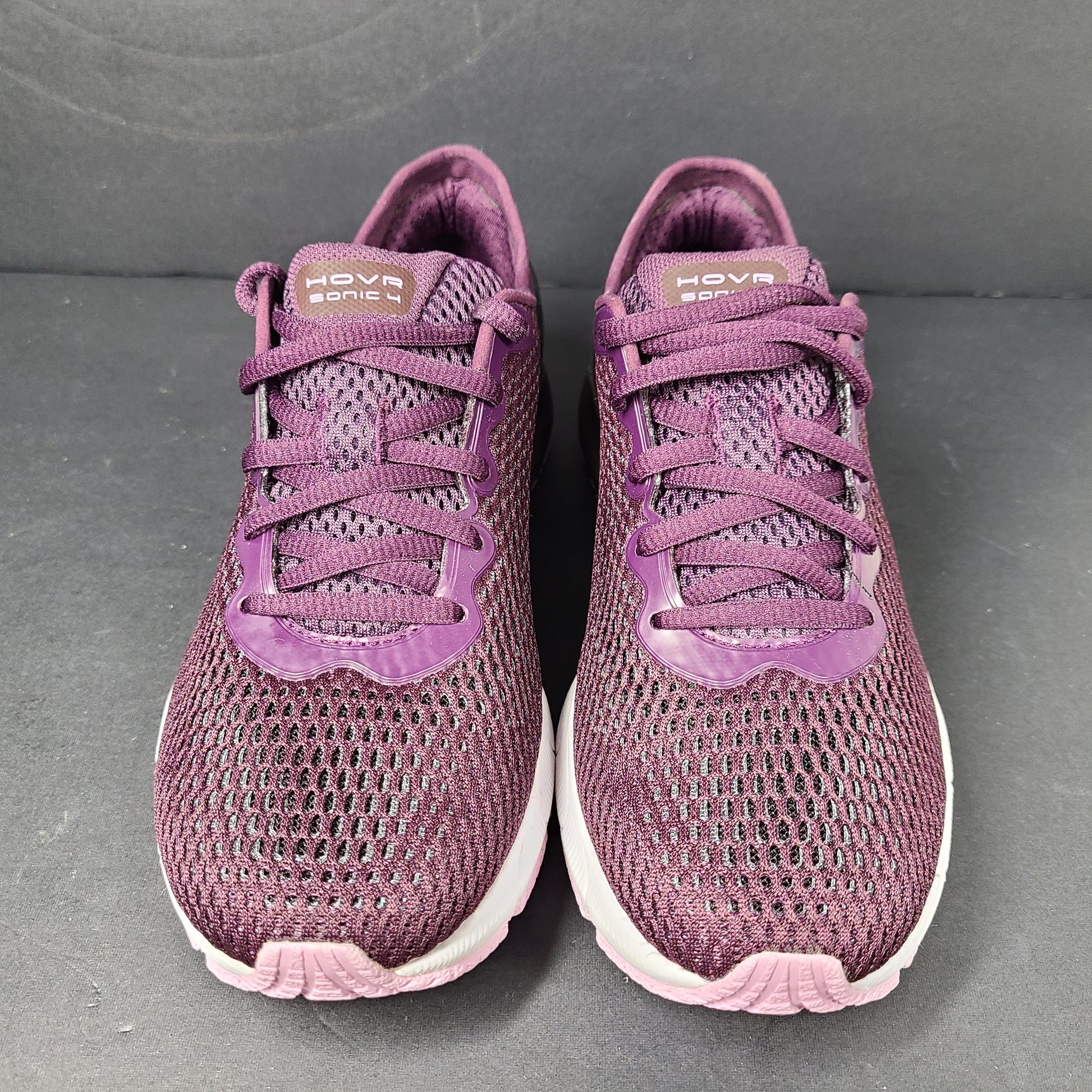 A pair of purple Under Armour HOVR Sonic 4 running shoes for women size 5.