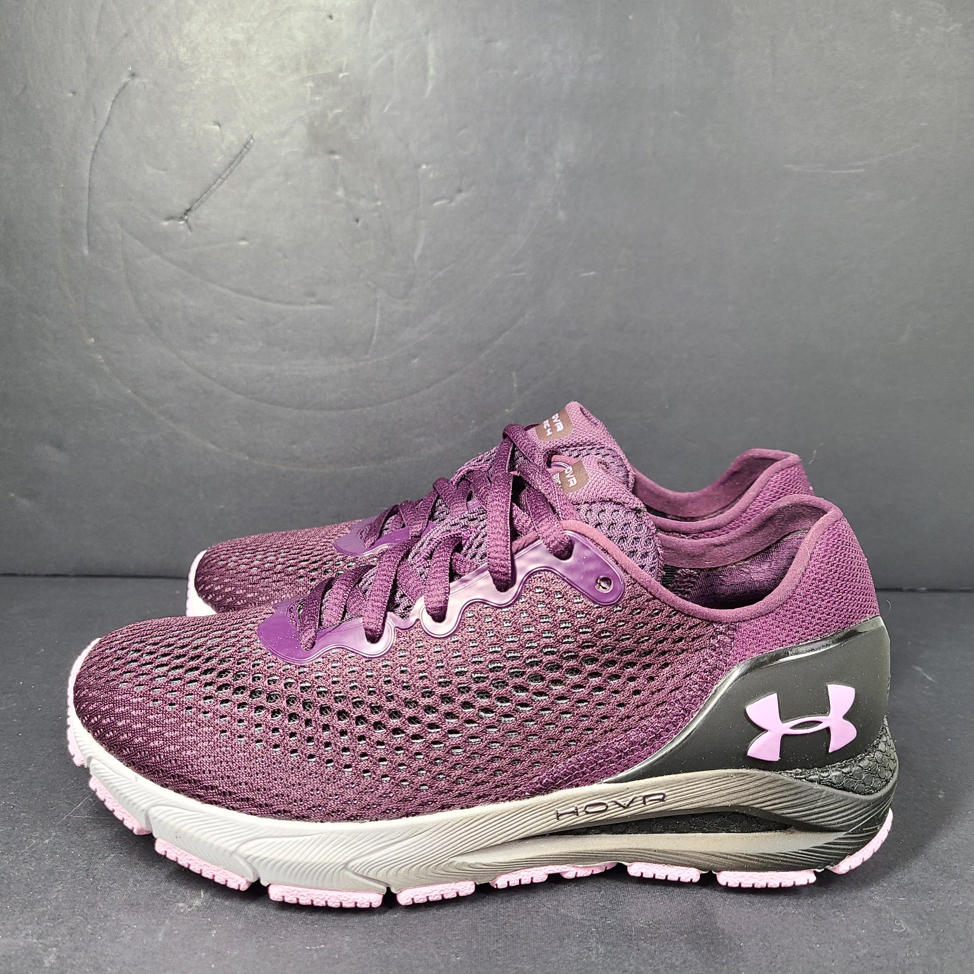 A pair of purple Under Armour HOVR Sonic 4 running shoes for women size 5.