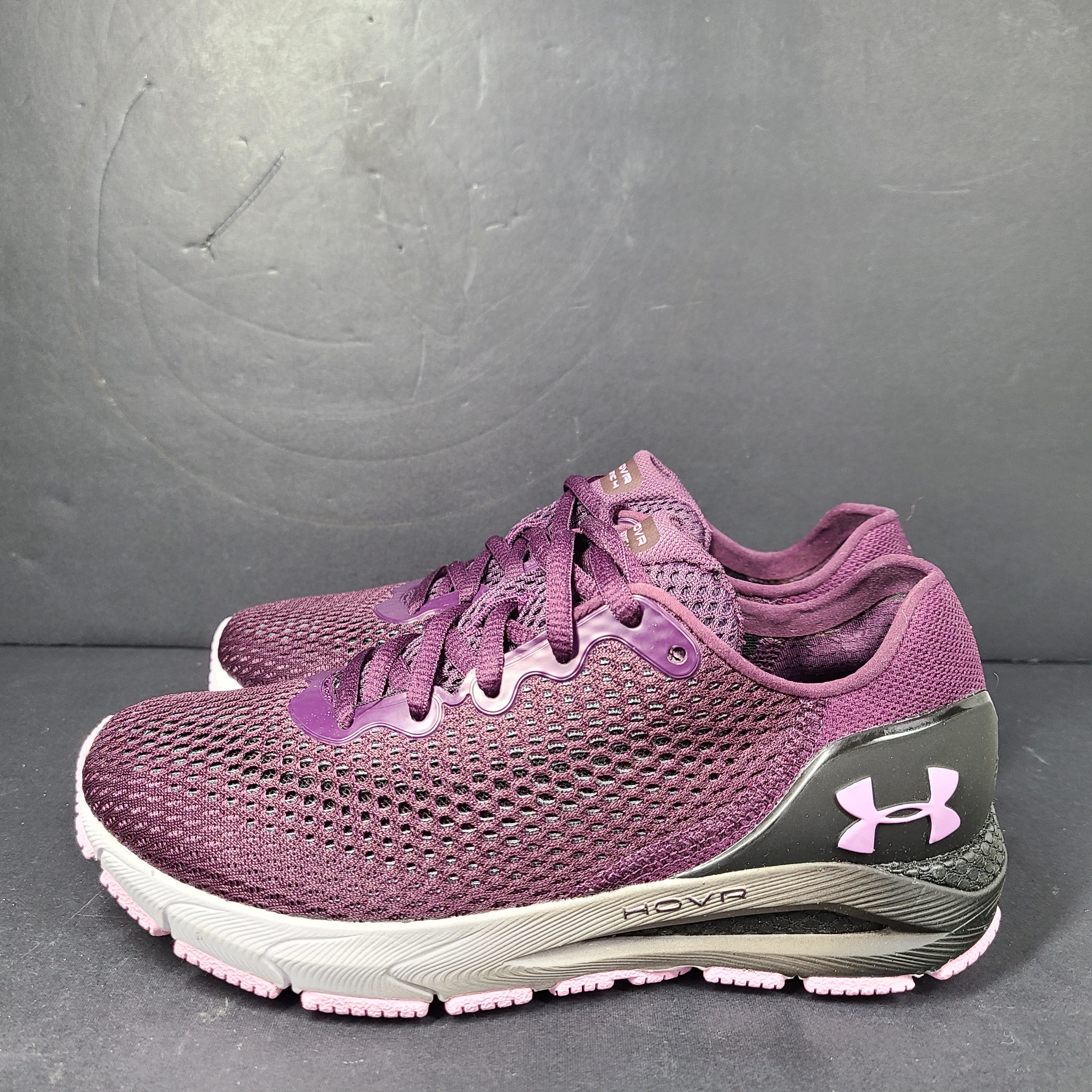 A pair of purple Under Armour HOVR Sonic 4 running shoes for women size 5.