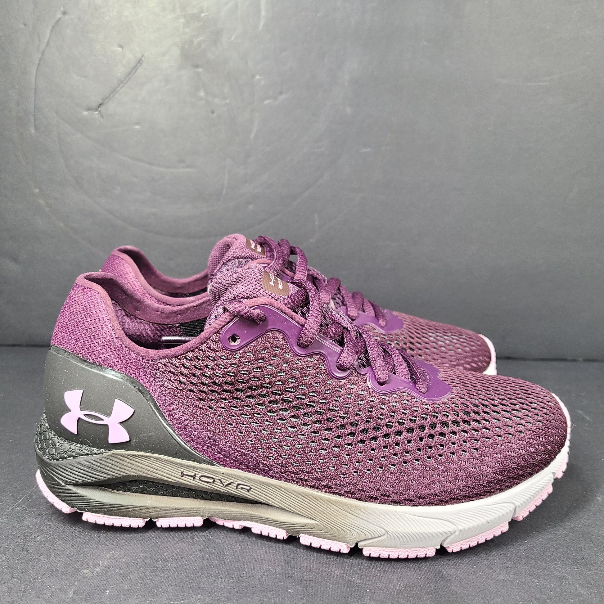A pair of purple Under Armour HOVR Sonic 4 running shoes for women size 5.