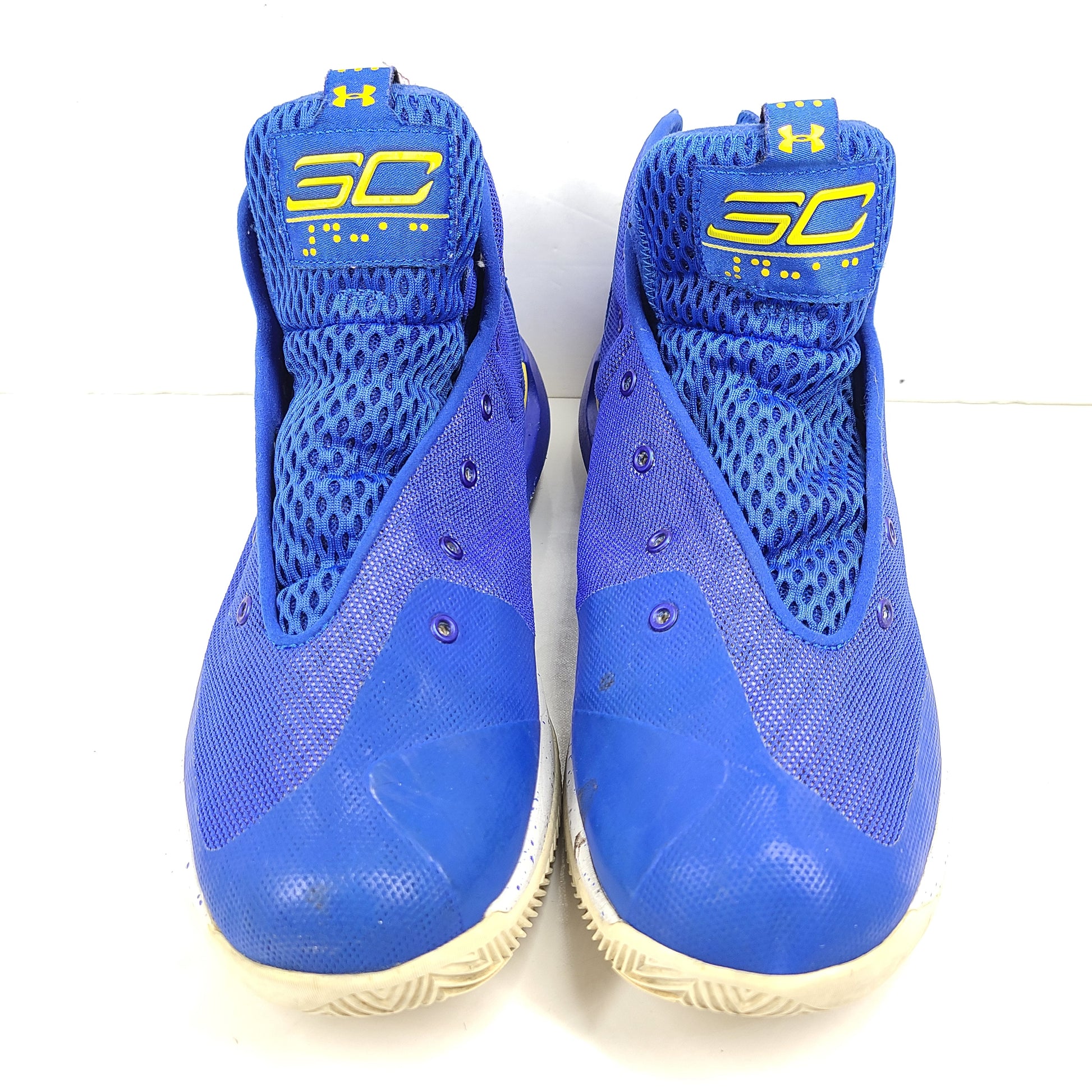 A pair of blue and yellow Under Armour basketball sneakers