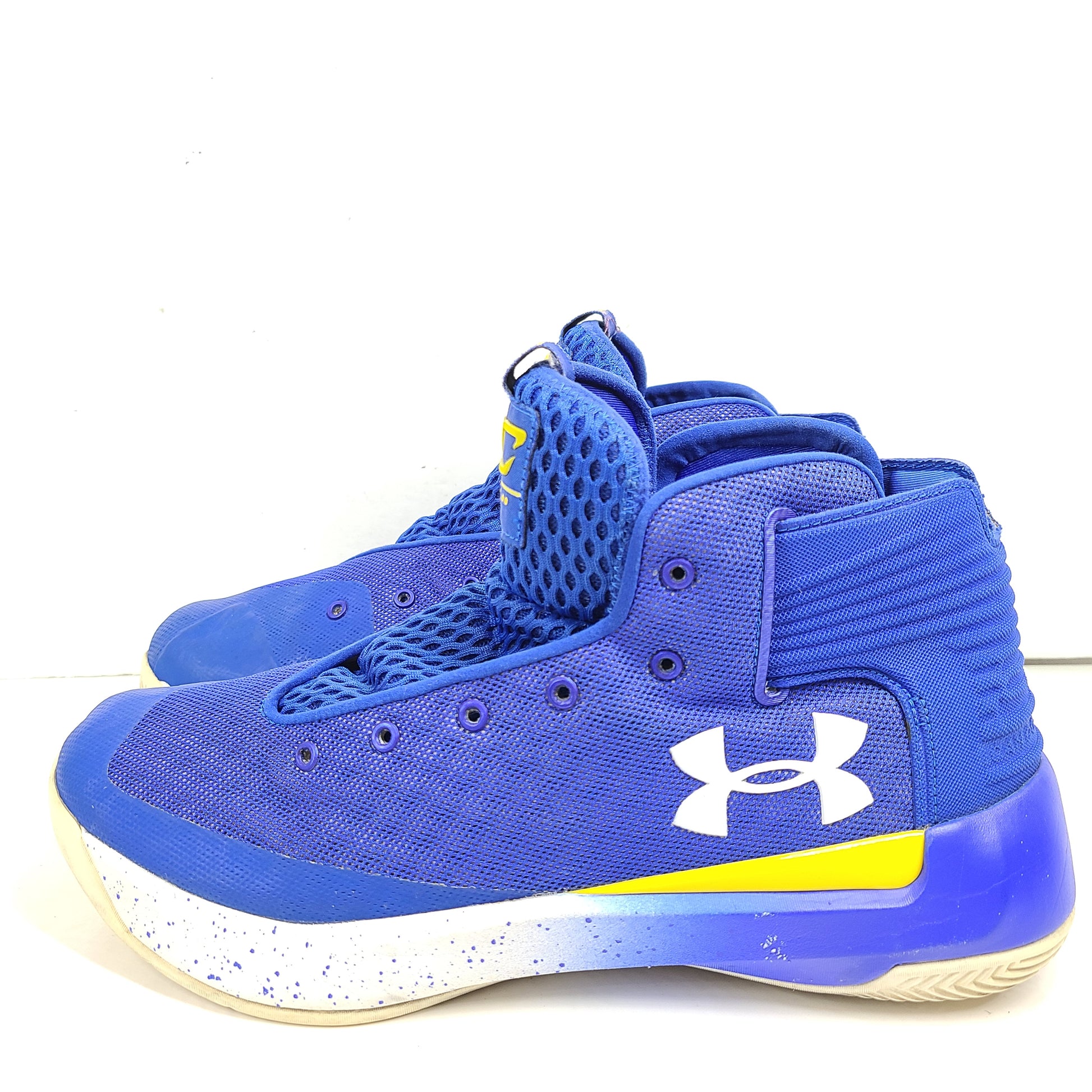 A pair of blue and yellow Under Armour basketball sneakers