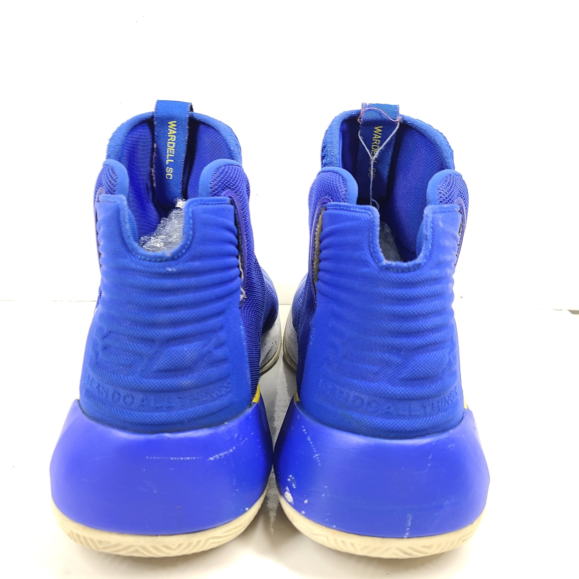 A pair of blue and yellow Under Armour basketball sneakers