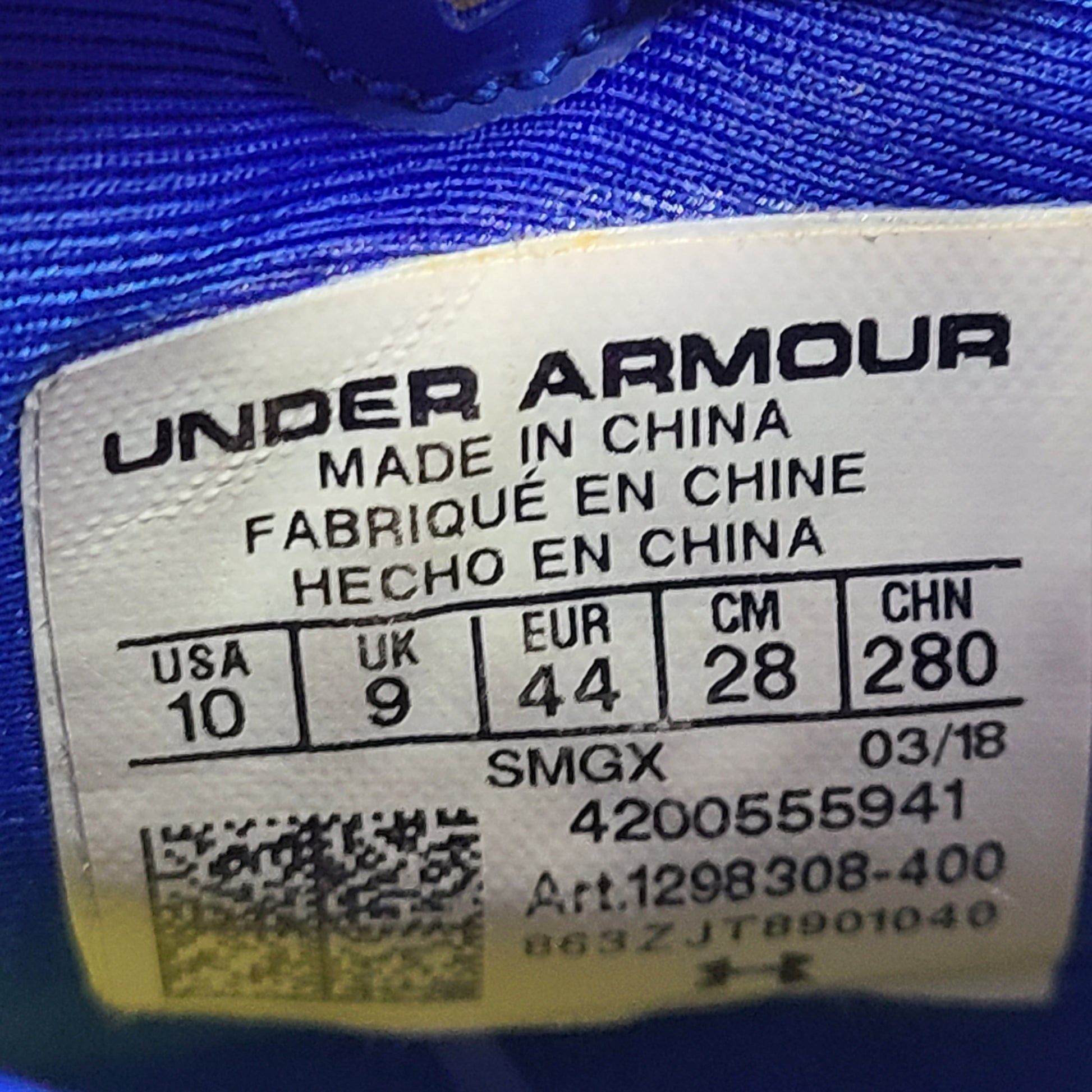 A pair of blue and yellow Under Armour basketball sneakers