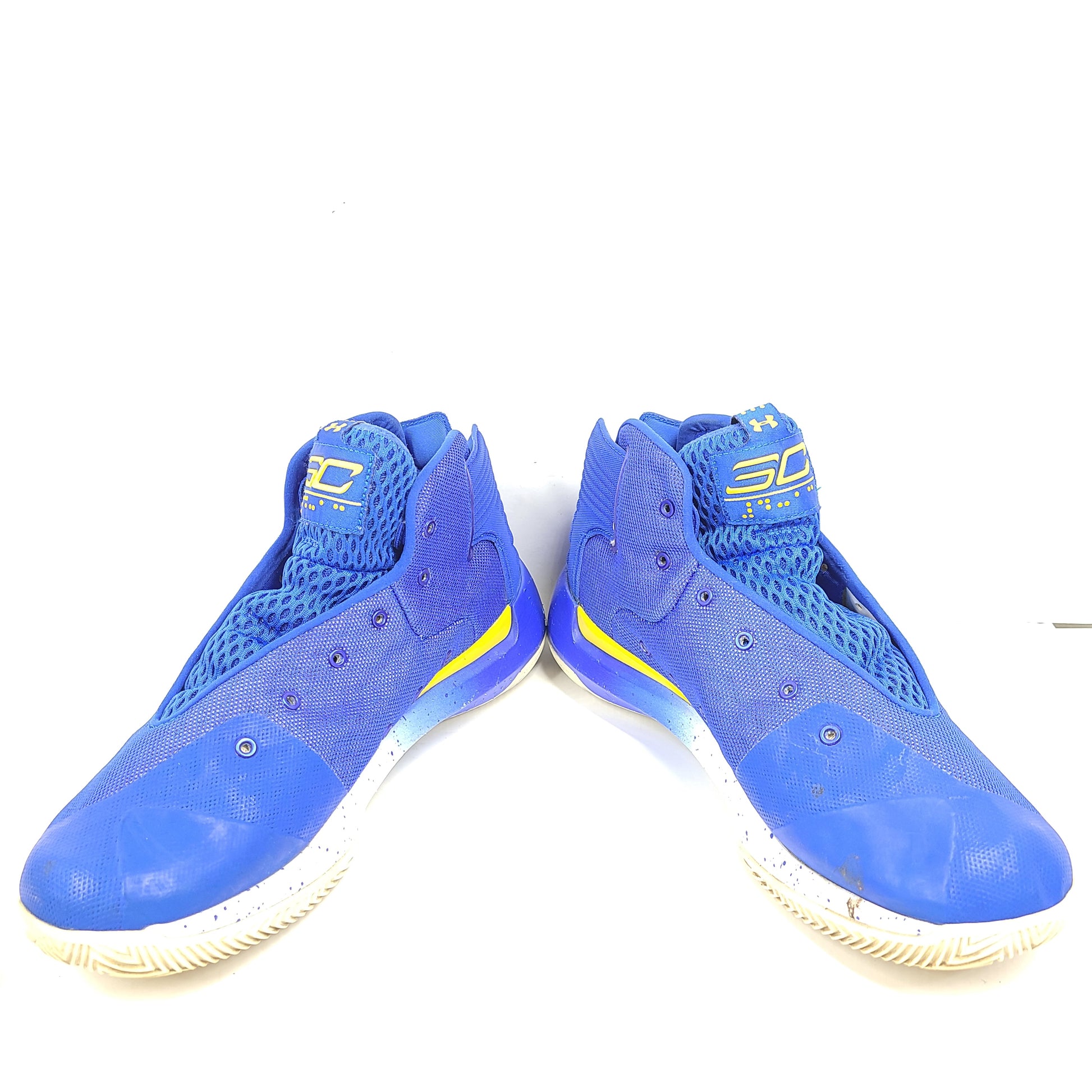 A pair of blue and yellow Under Armour basketball sneakers