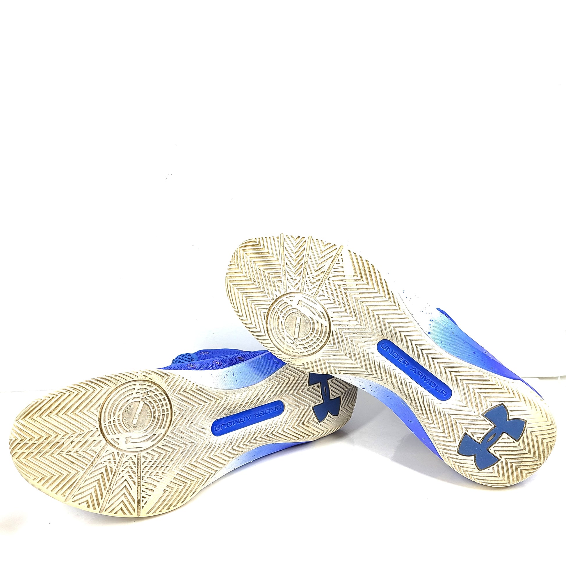 A pair of blue and yellow Under Armour basketball sneakers