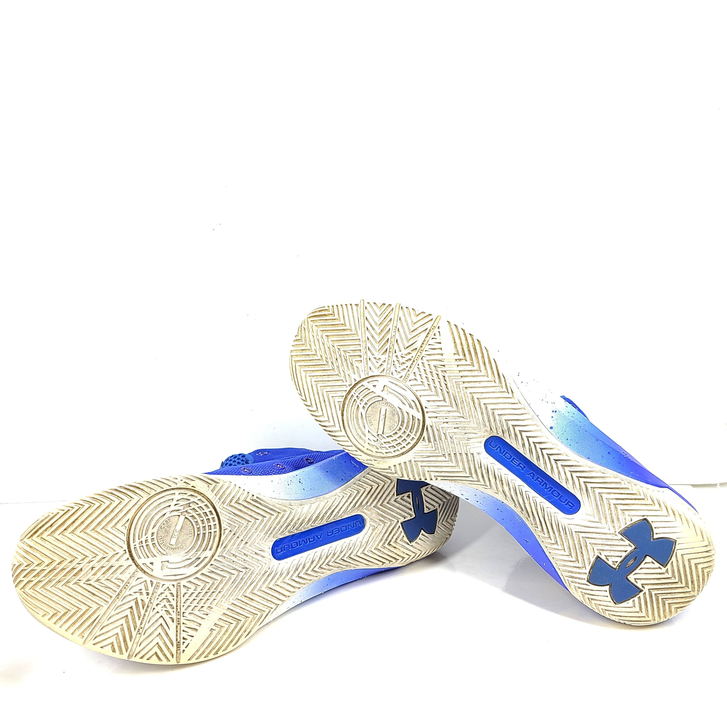 A pair of blue and yellow Under Armour basketball sneakers