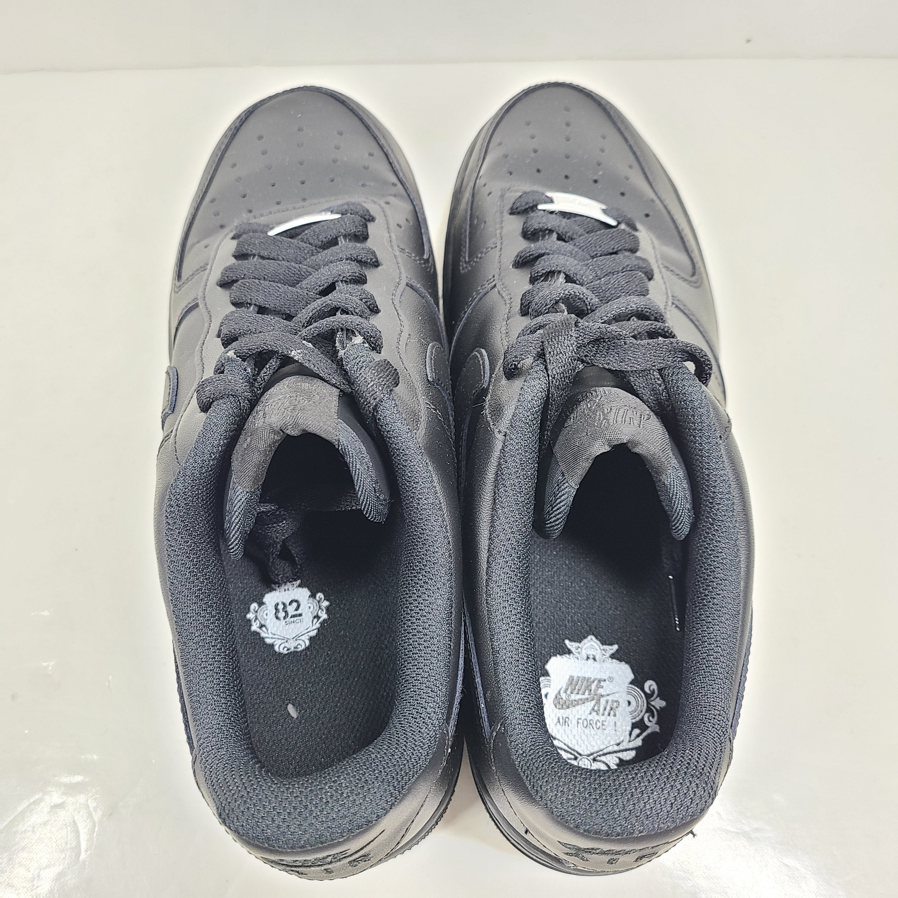 A pair of black Nike Air Force 1 Low sneakers for men