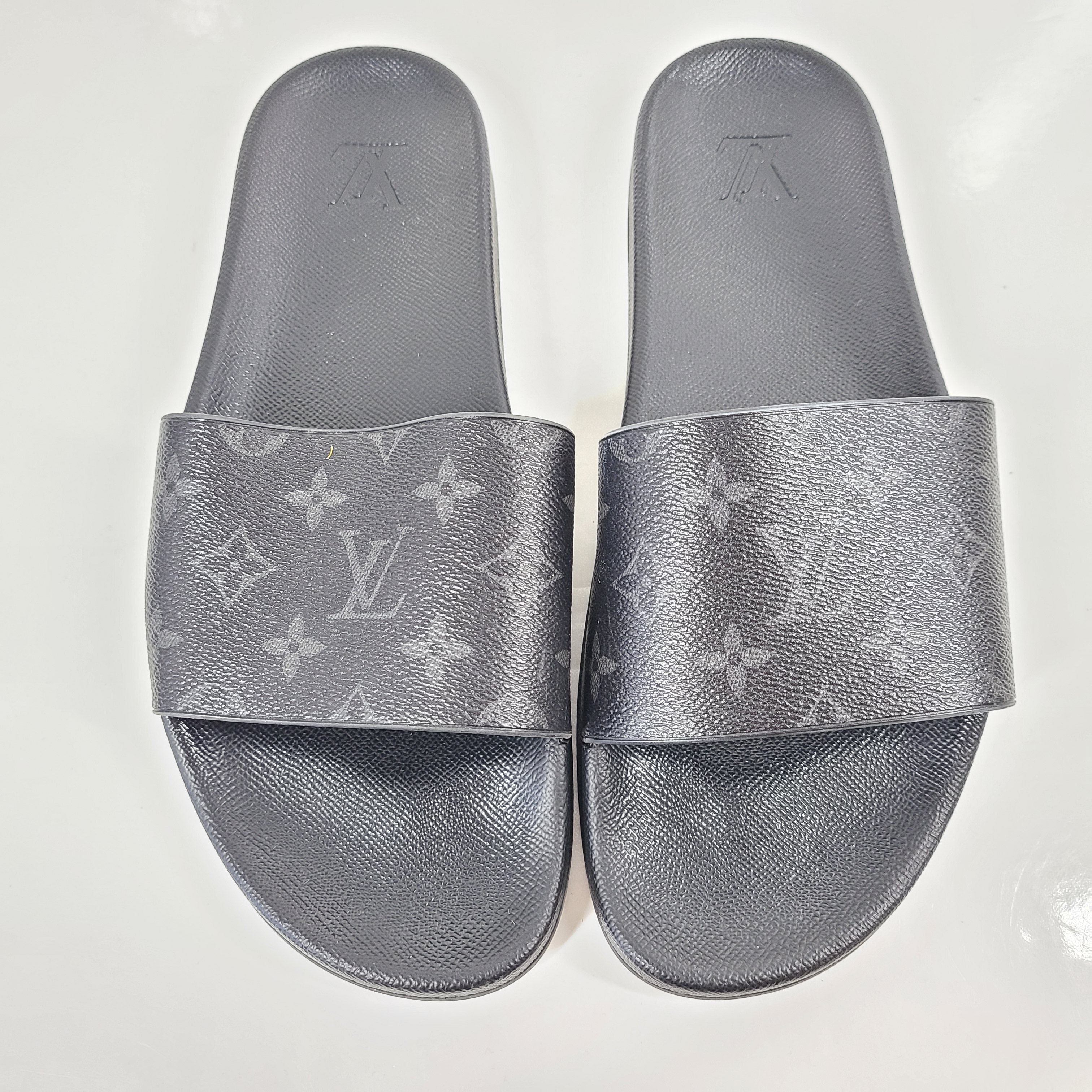 A pair of men's Louis Vuitton Monogram Slippers in size 9