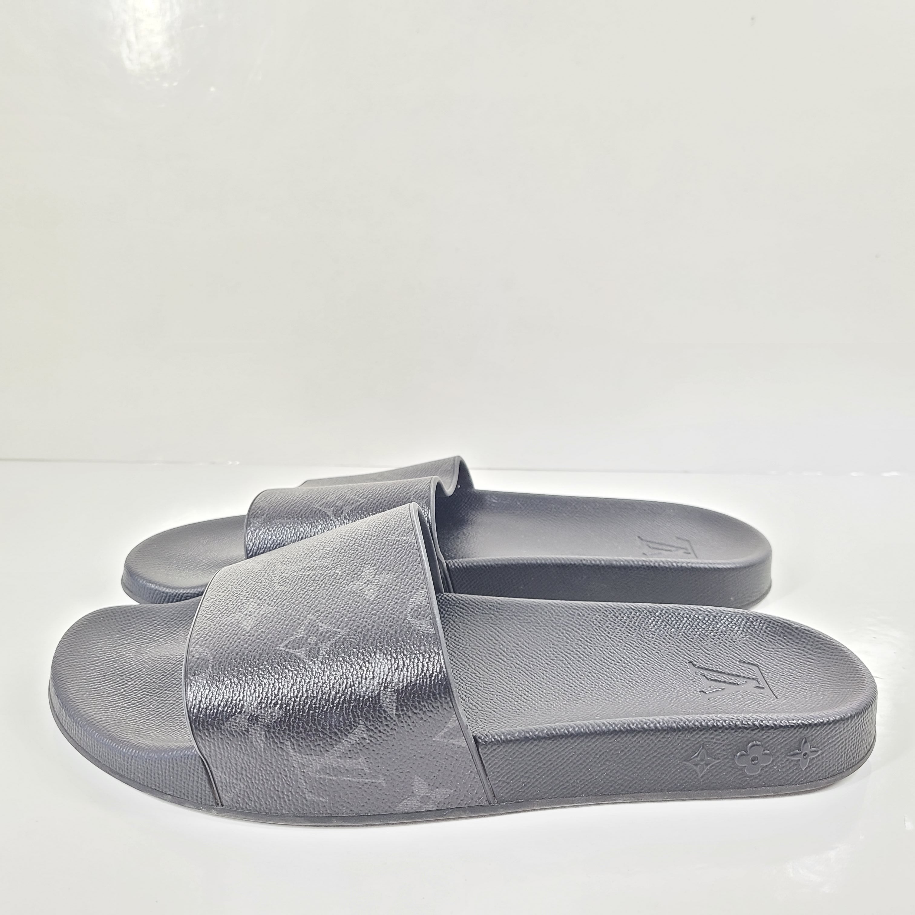 A pair of men's Louis Vuitton Monogram Slippers in size 9