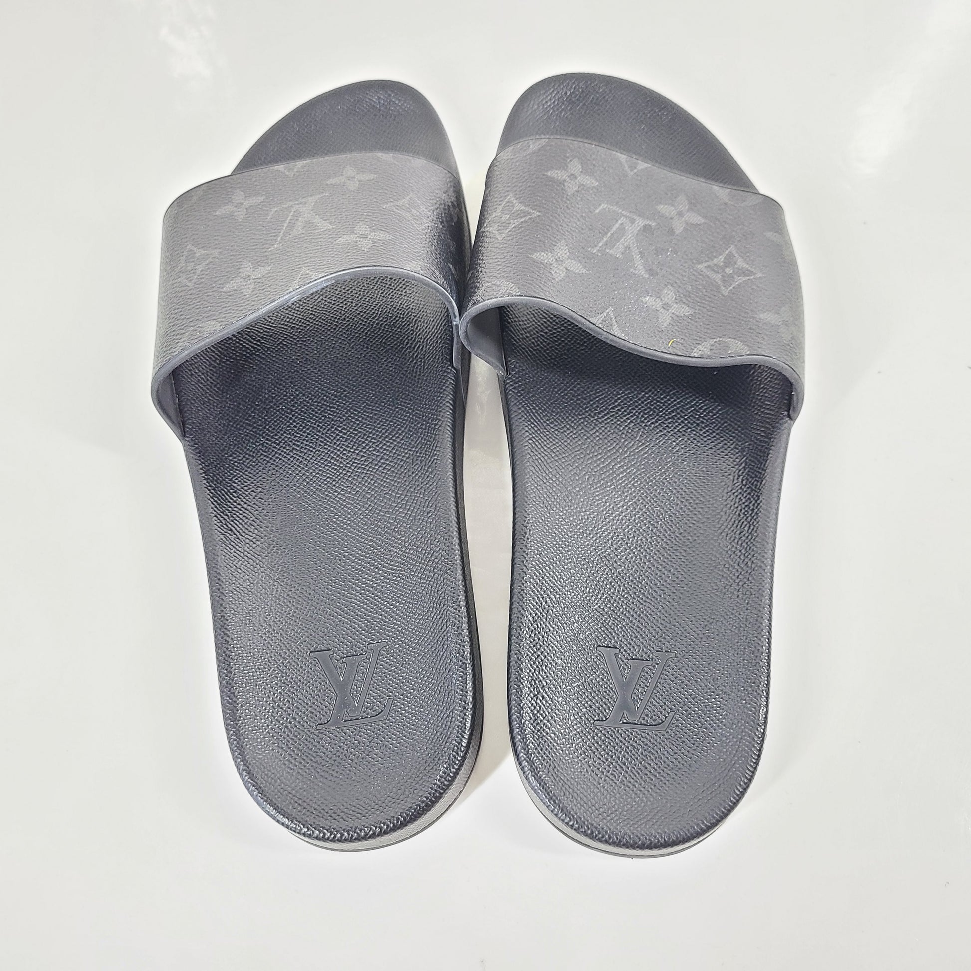 A pair of men's Louis Vuitton Monogram Slippers in size 9