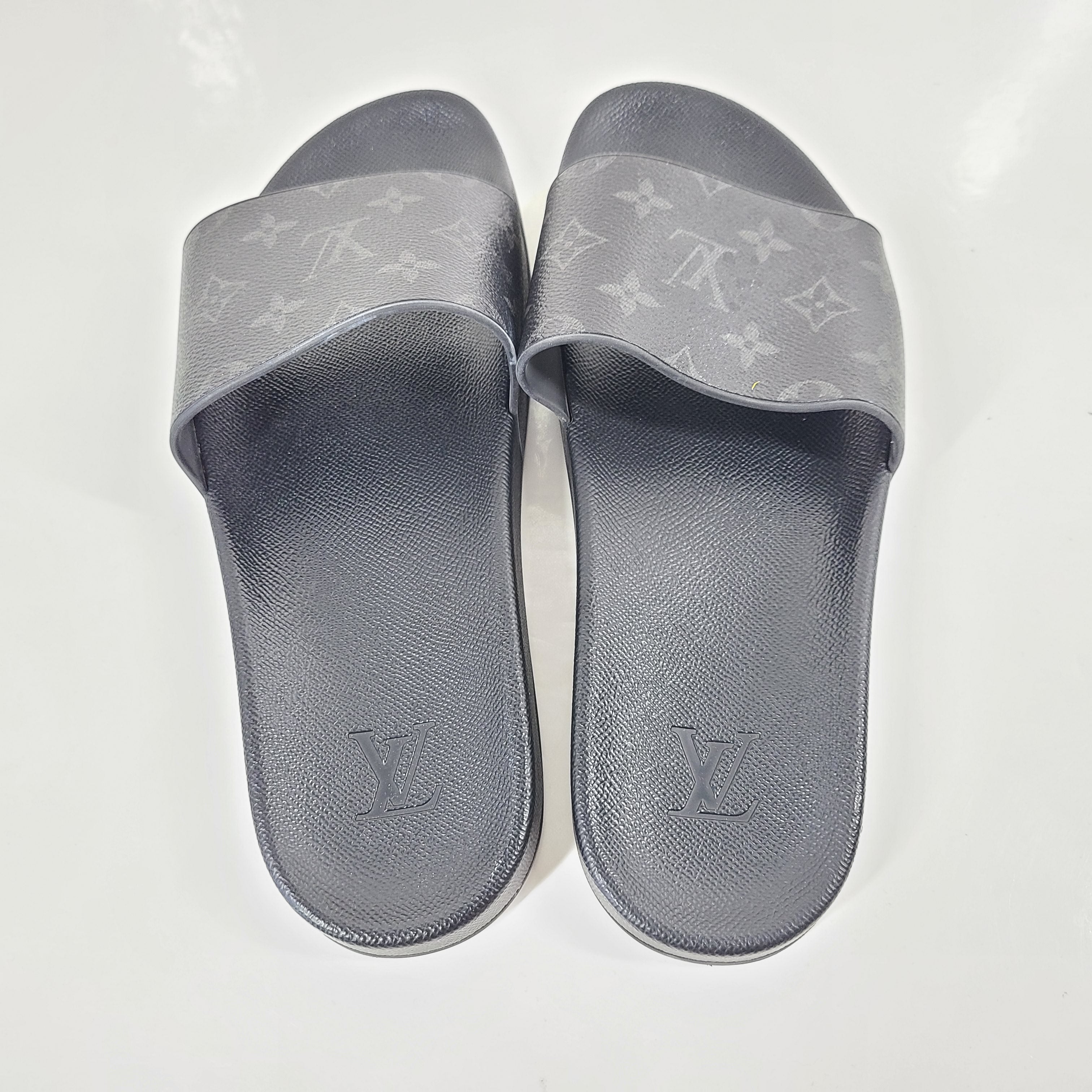 A pair of men's Louis Vuitton Monogram Slippers in size 9