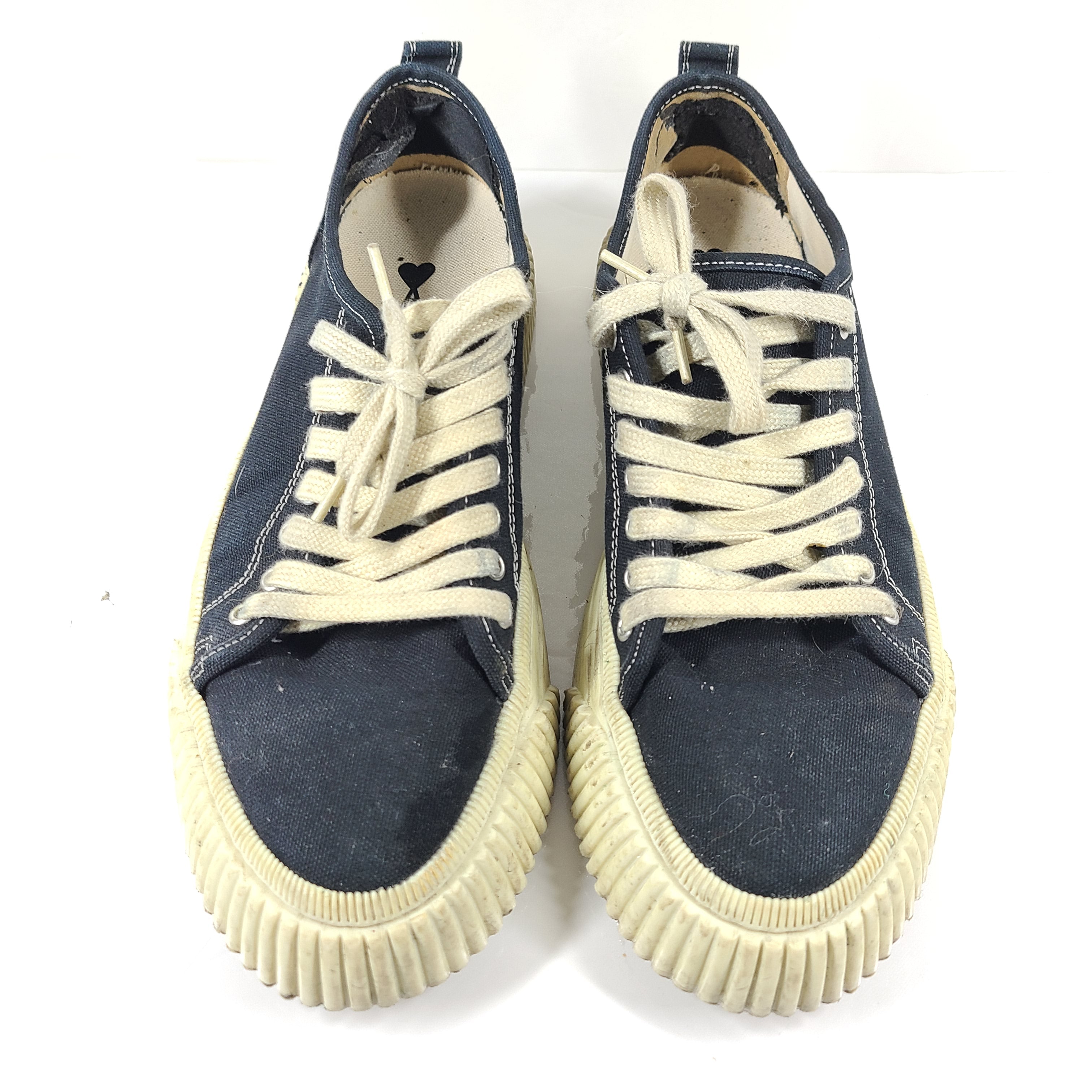 A pair of men's navy blue canvas sneakers by AMI Alexandre Mattiussi.