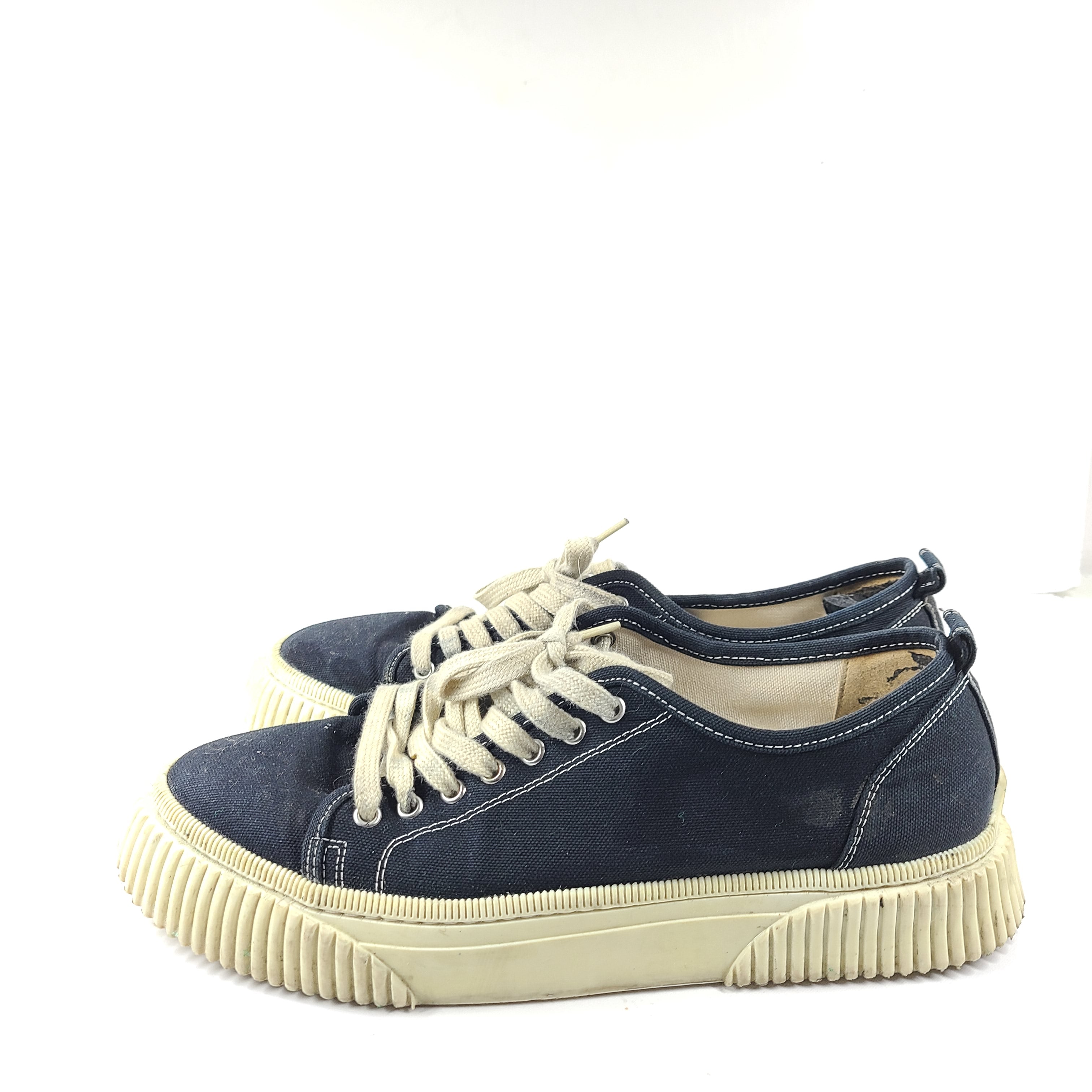 A pair of men's navy blue canvas sneakers by AMI Alexandre Mattiussi.