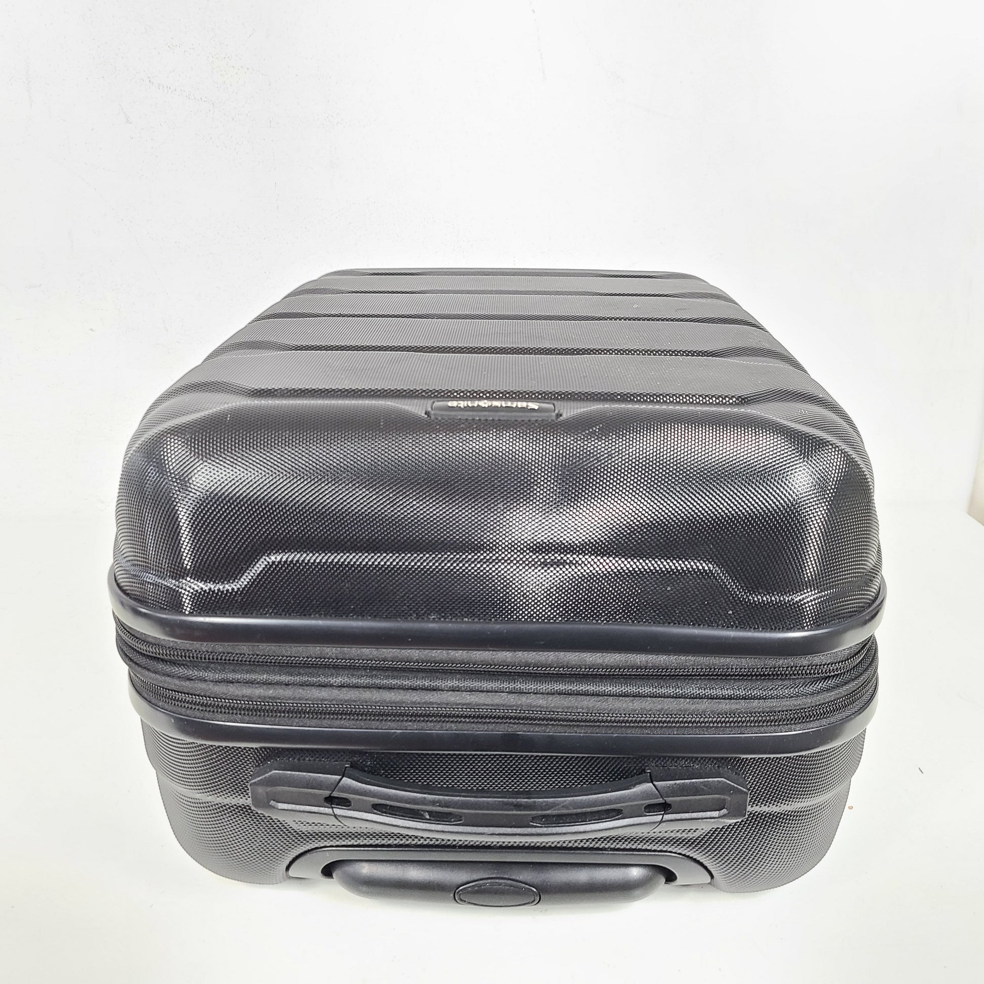 A black Samsonite spinner luggage.
