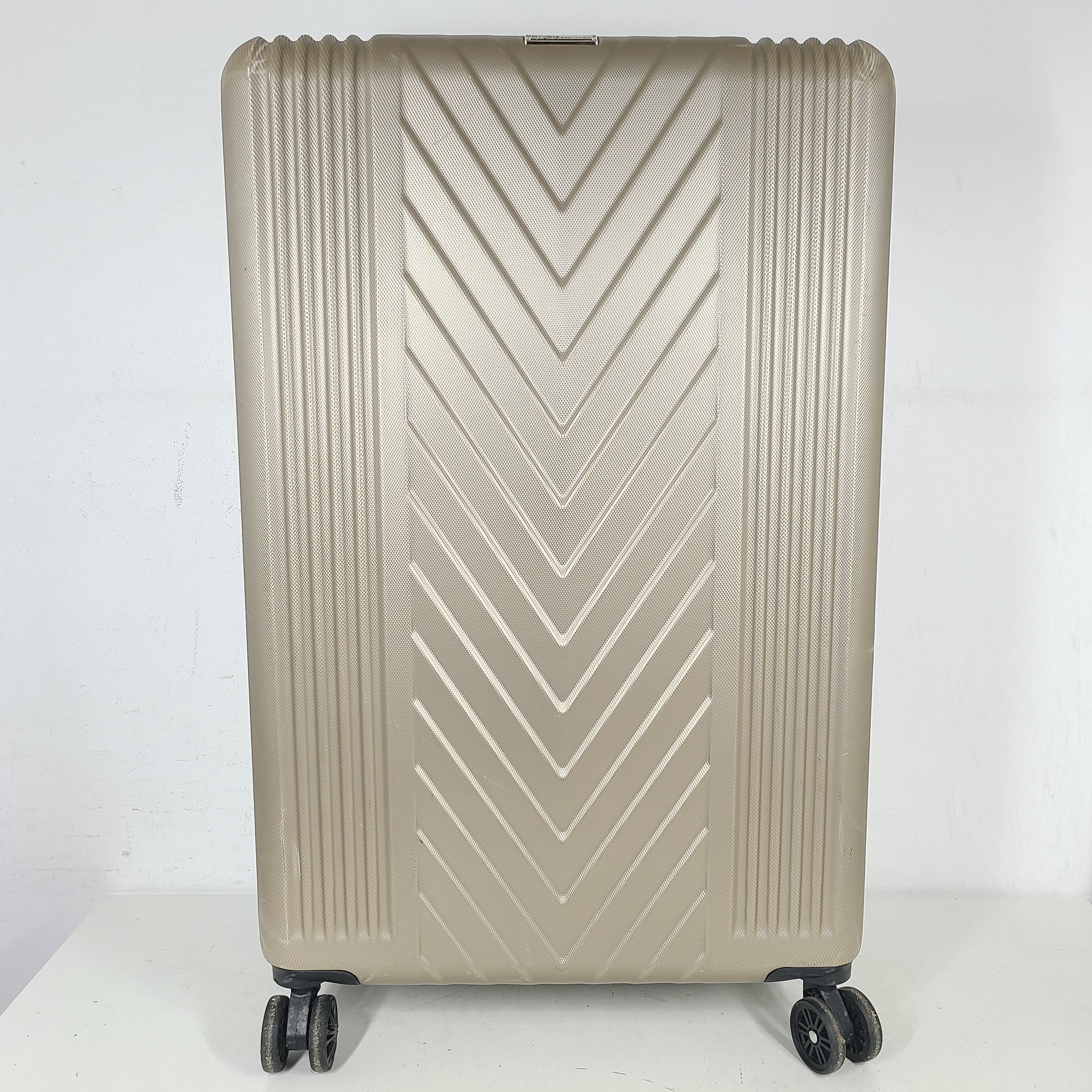 A stylish gold BCBGeneration suitcase made of 100% ABS material.