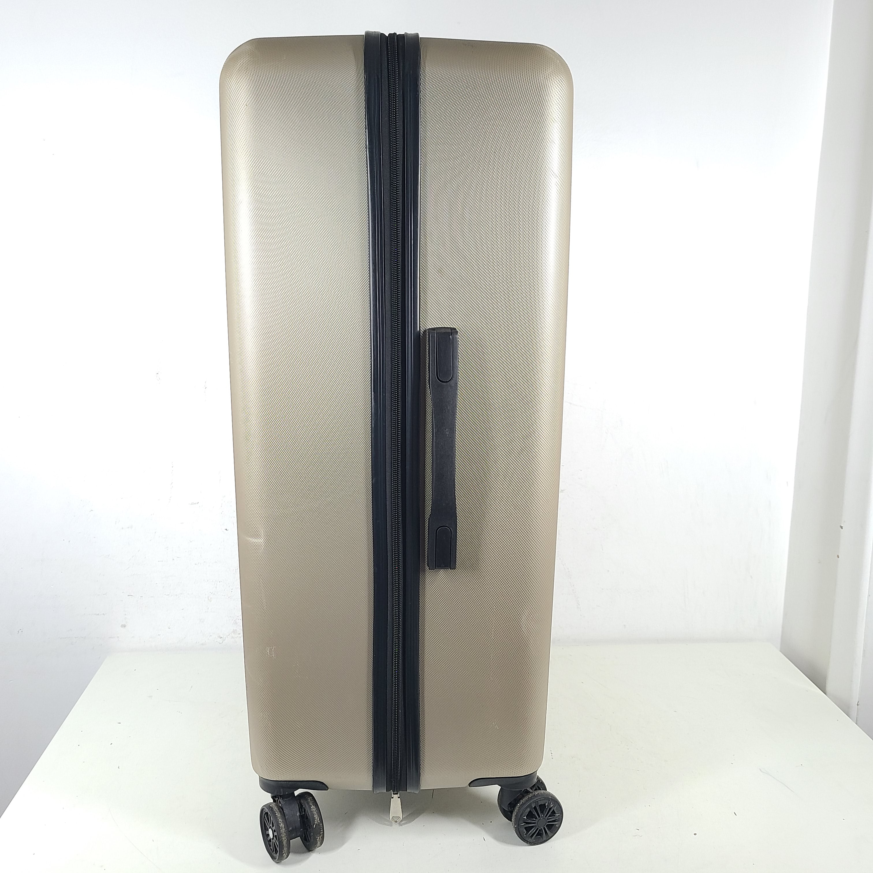 A stylish gold BCBGeneration suitcase made of 100% ABS material.