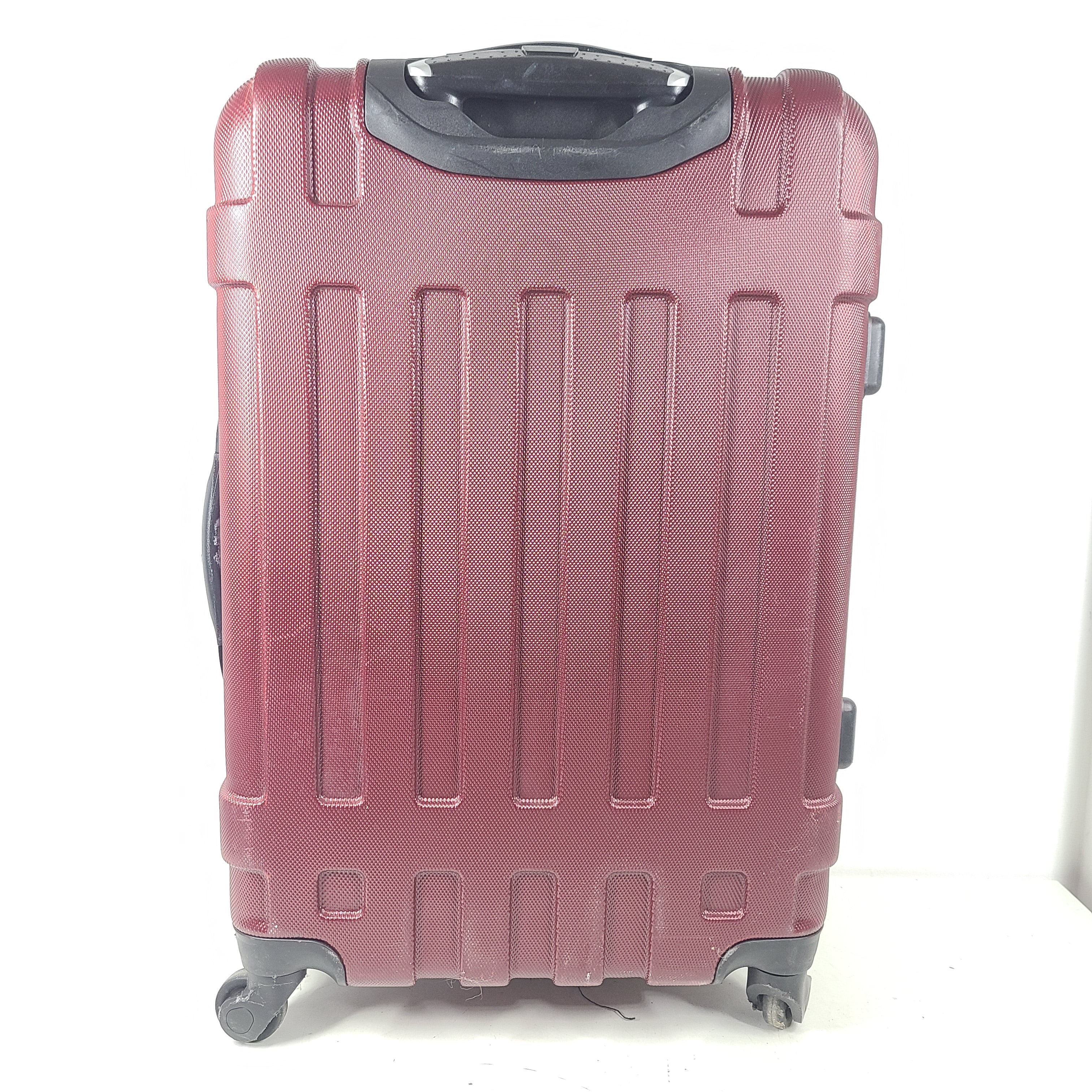 A burgundy Samsonite hardside spinner suitcase