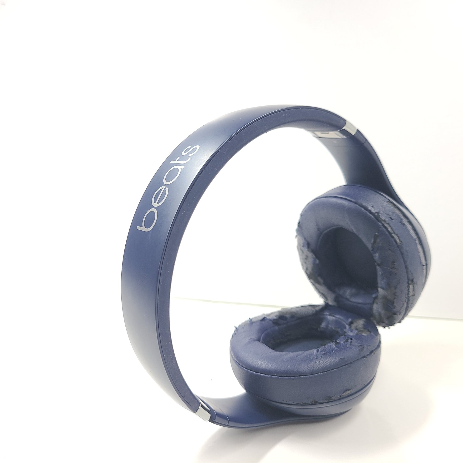 A pair of blue Beats wireless headphones.