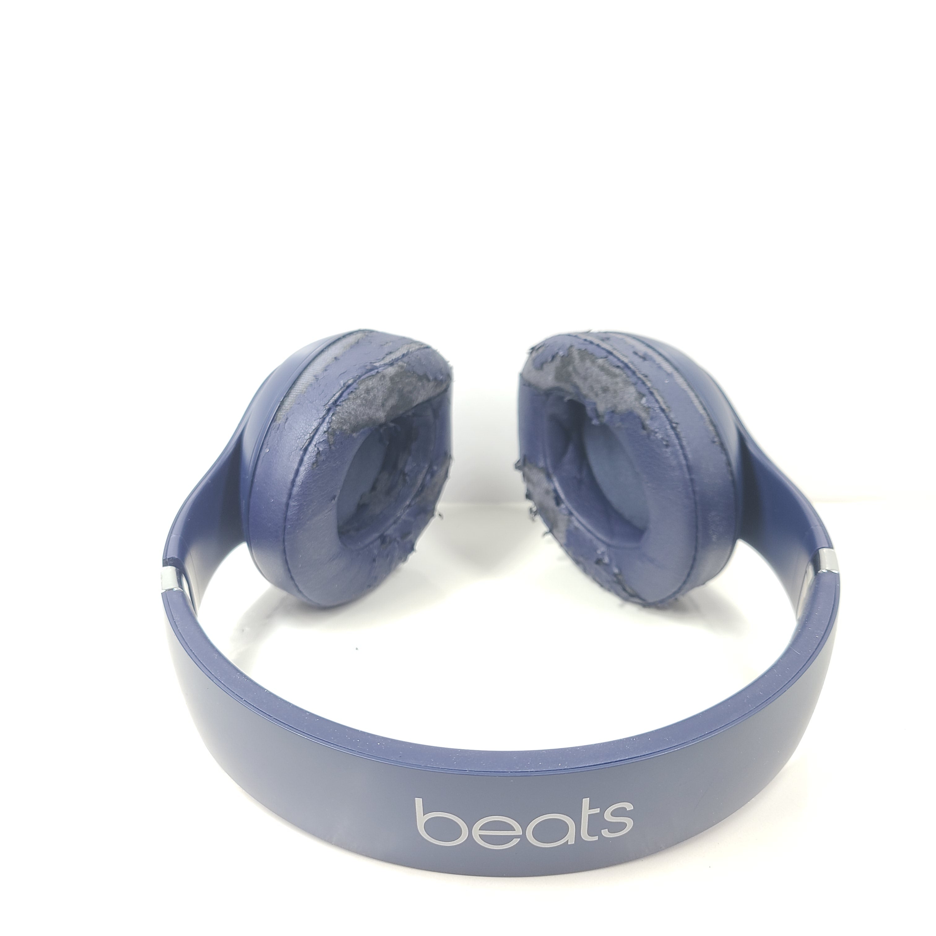 A pair of blue Beats wireless headphones.
