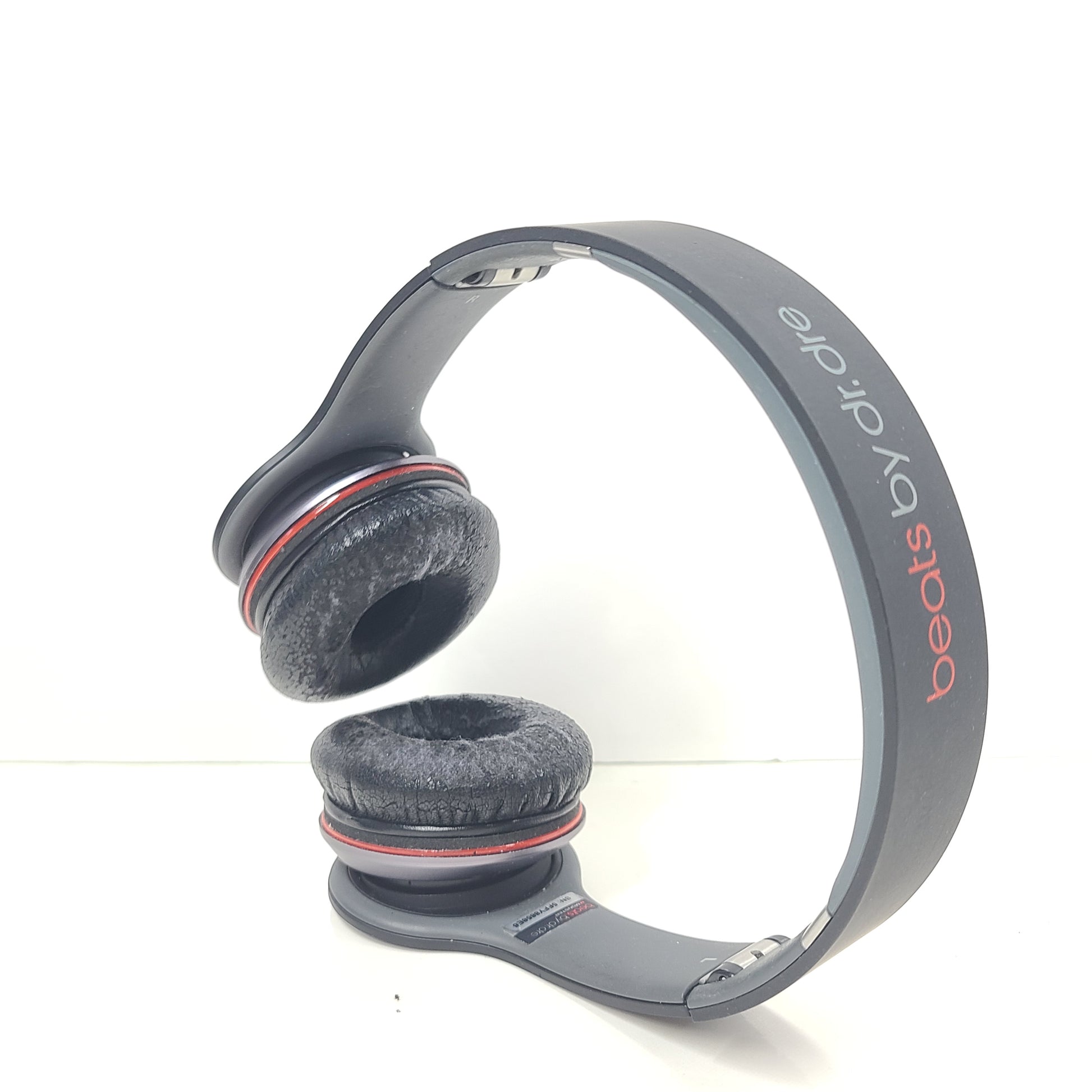 A pair of black and red Beats by Dr. Dre Solo HD Wired Headphones with case