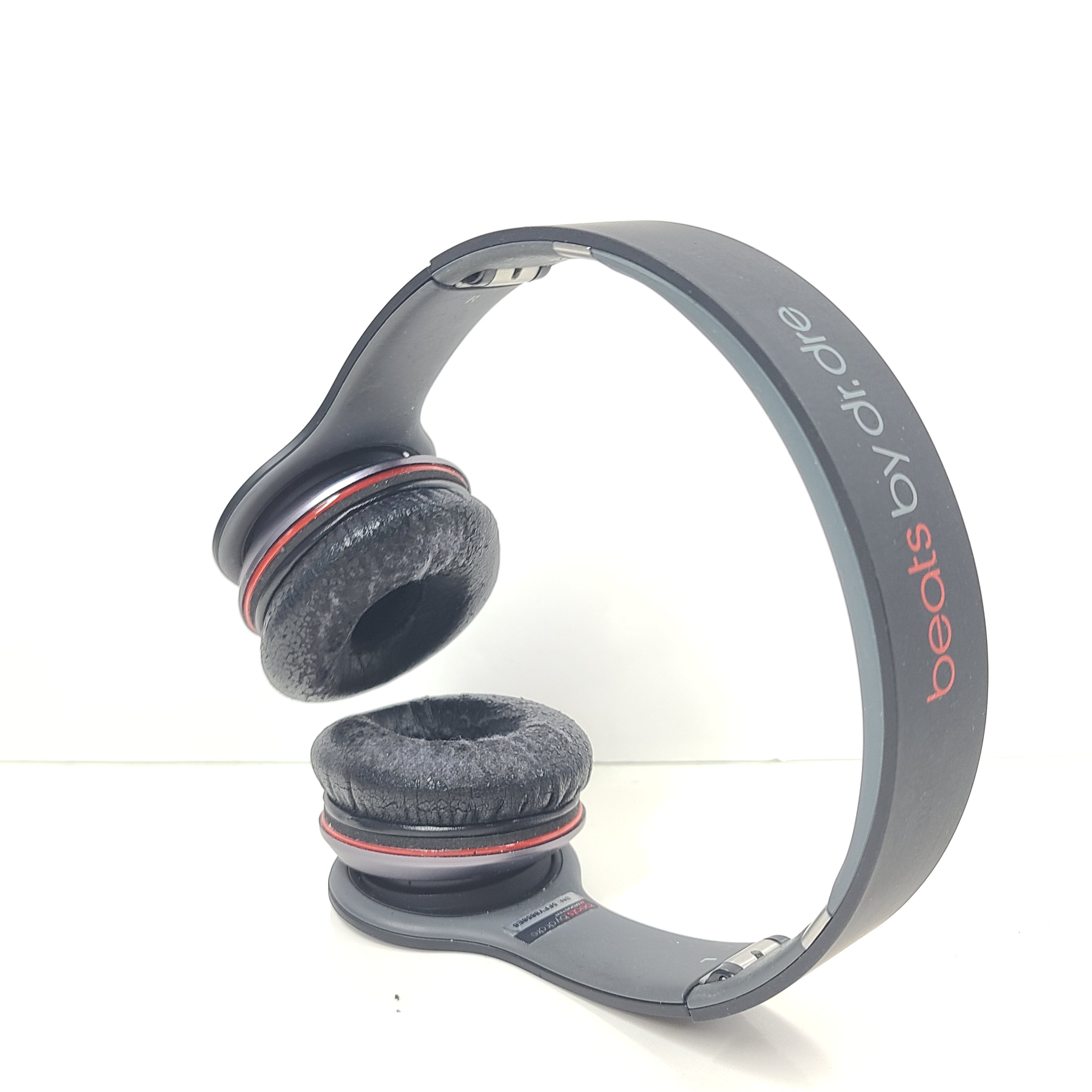 A pair of black and red Beats by Dr. Dre Solo HD Wired Headphones with case