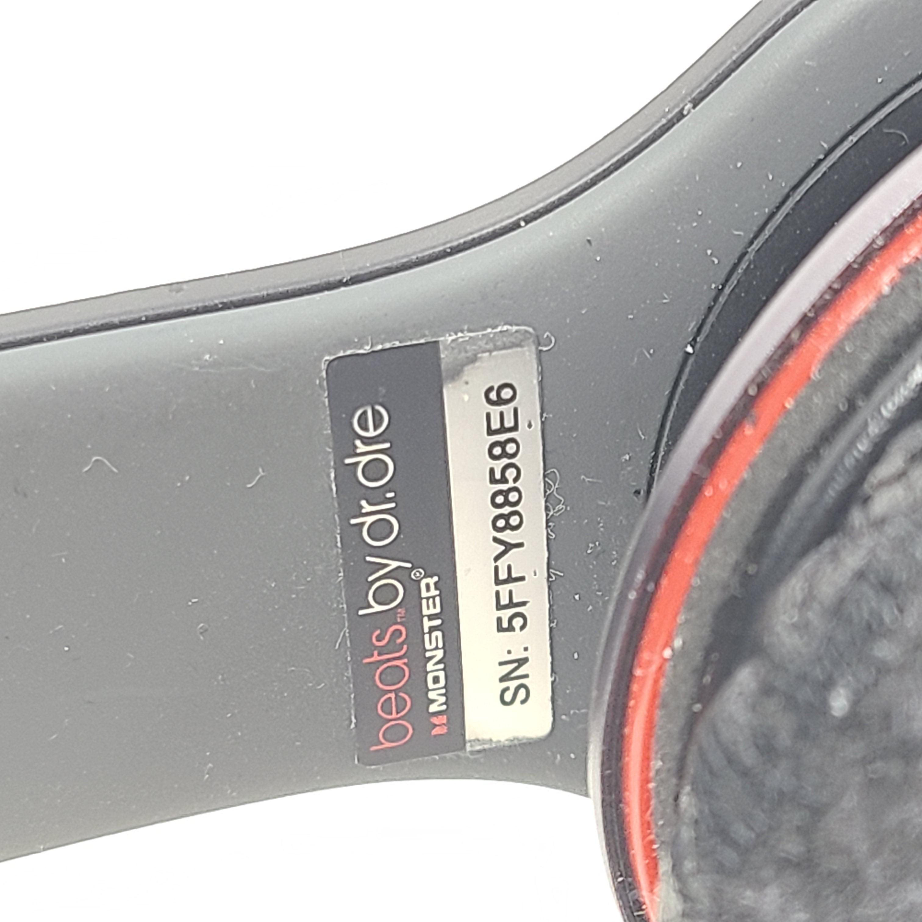 A pair of black and red Beats by Dr. Dre Solo HD Wired Headphones with case