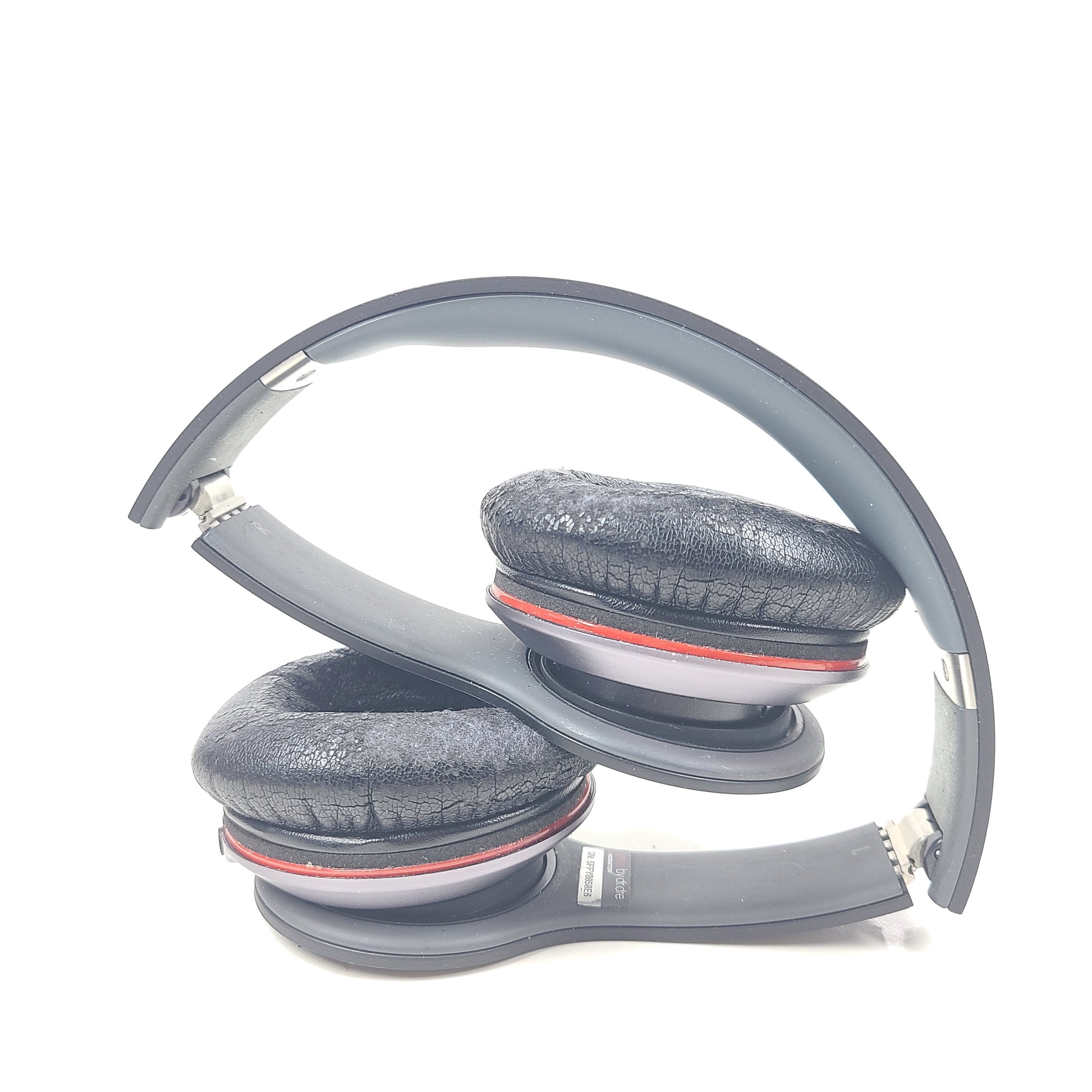 A pair of black and red Beats by Dr. Dre Solo HD Wired Headphones with case