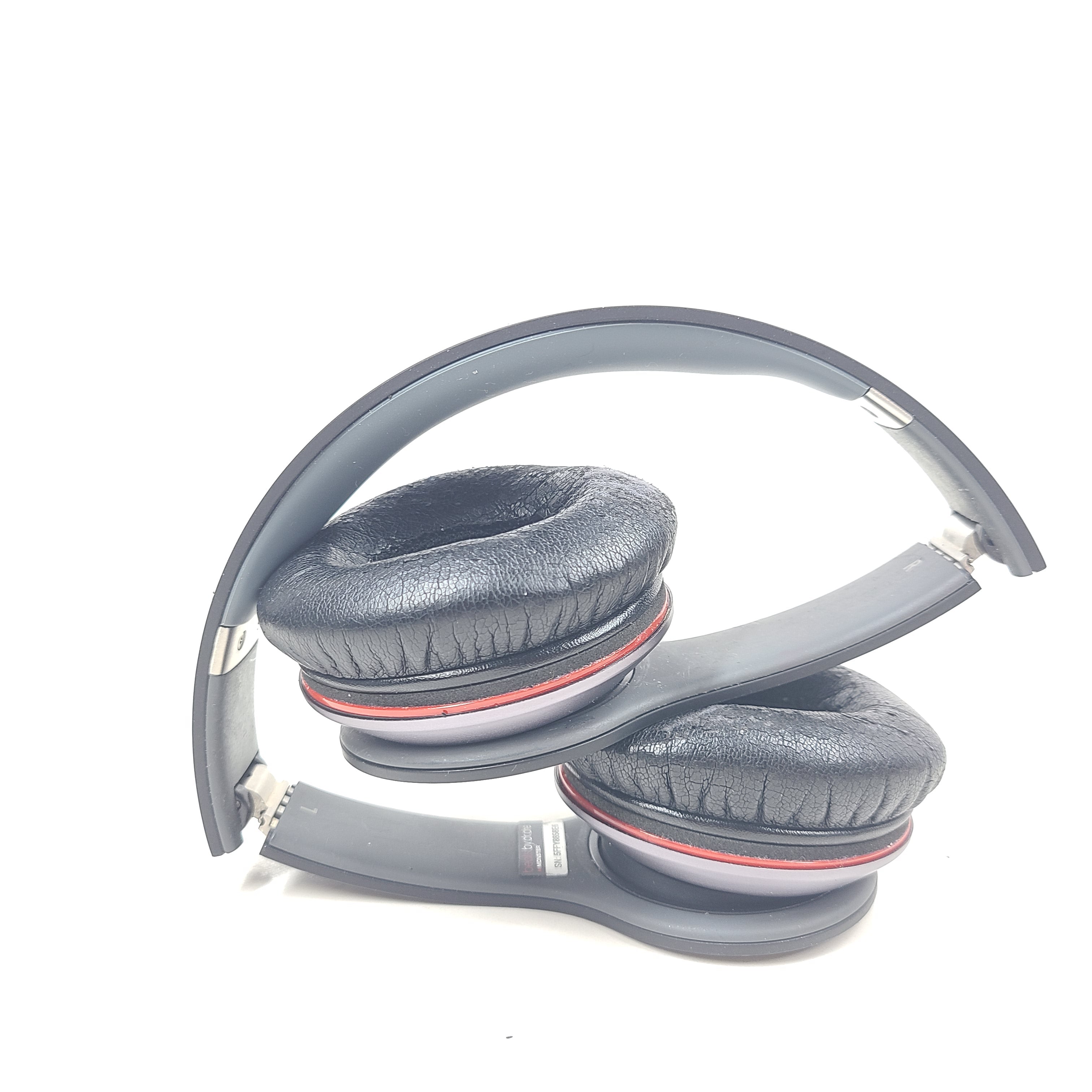 A pair of black and red Beats by Dr. Dre Solo HD Wired Headphones with case