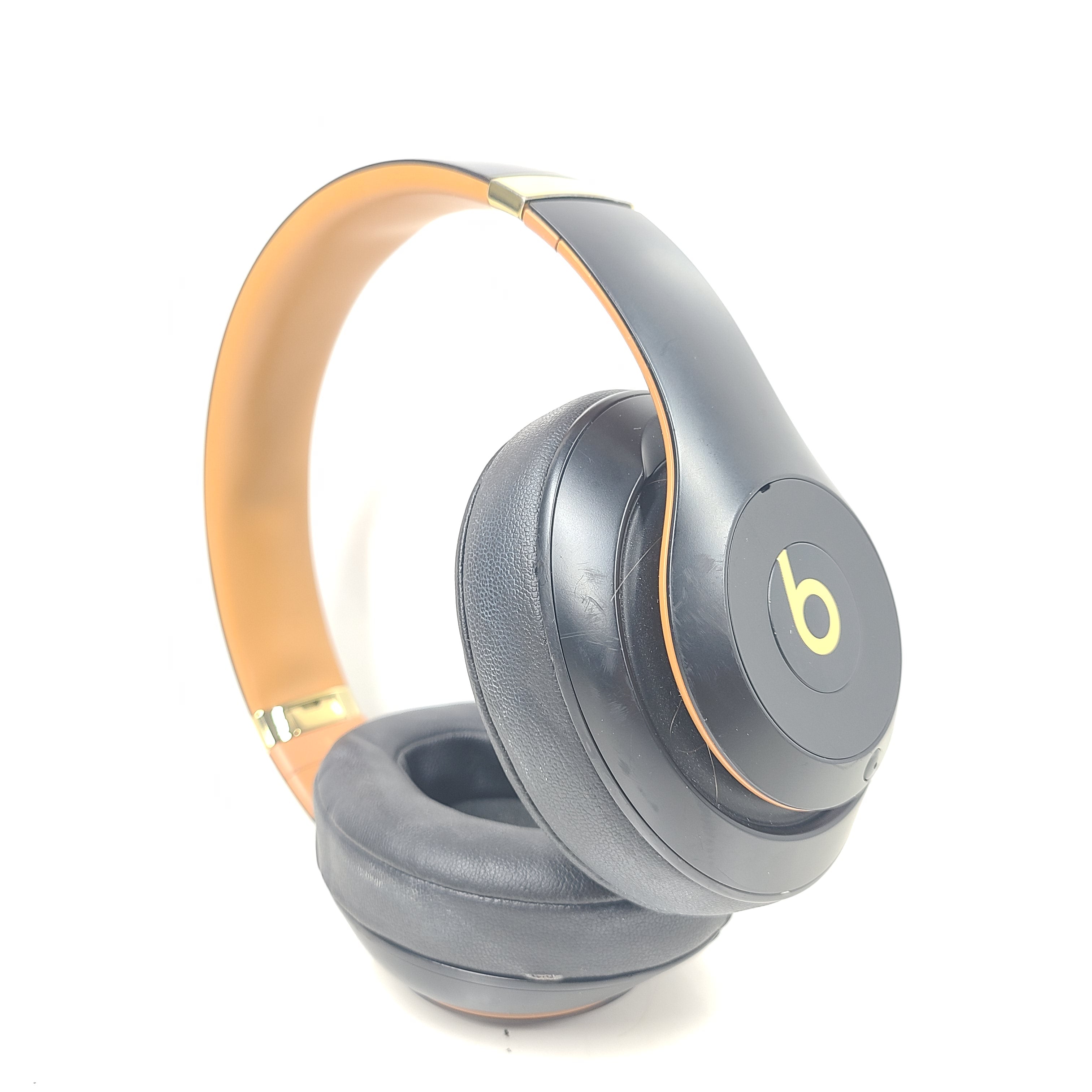A pair of black and gold Beats Wireless Over-Ear Headphones