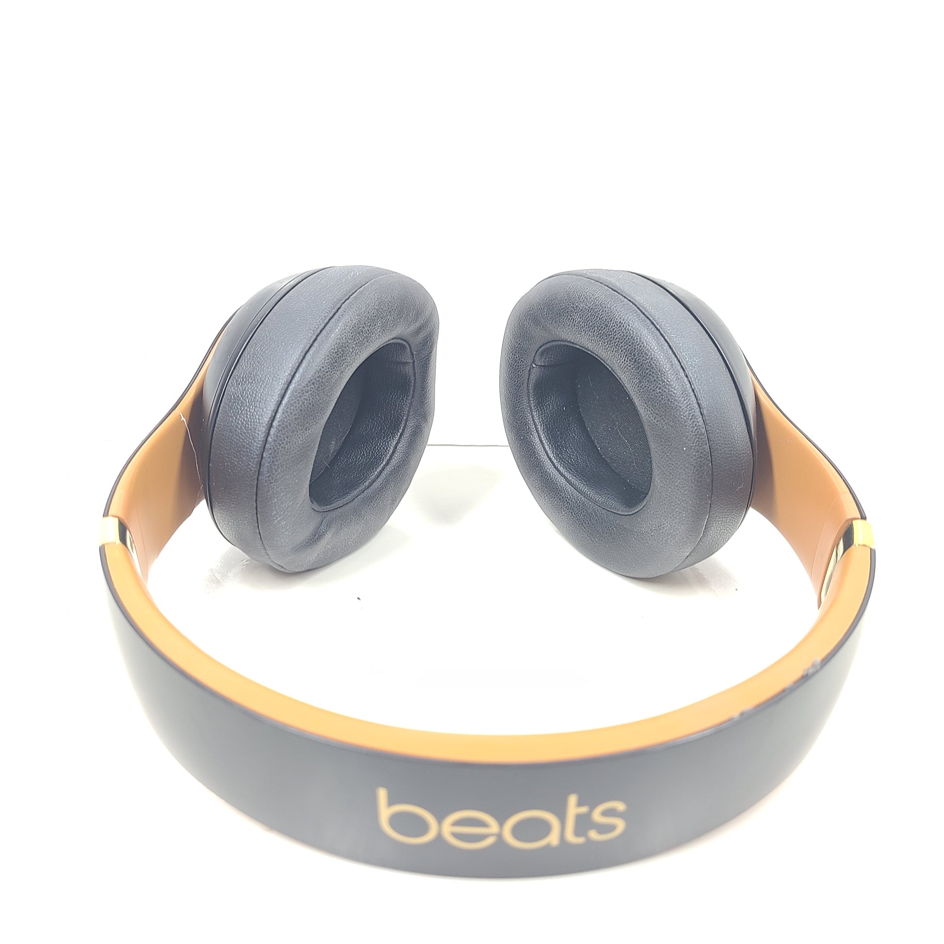 A pair of black and gold Beats Wireless Over-Ear Headphones