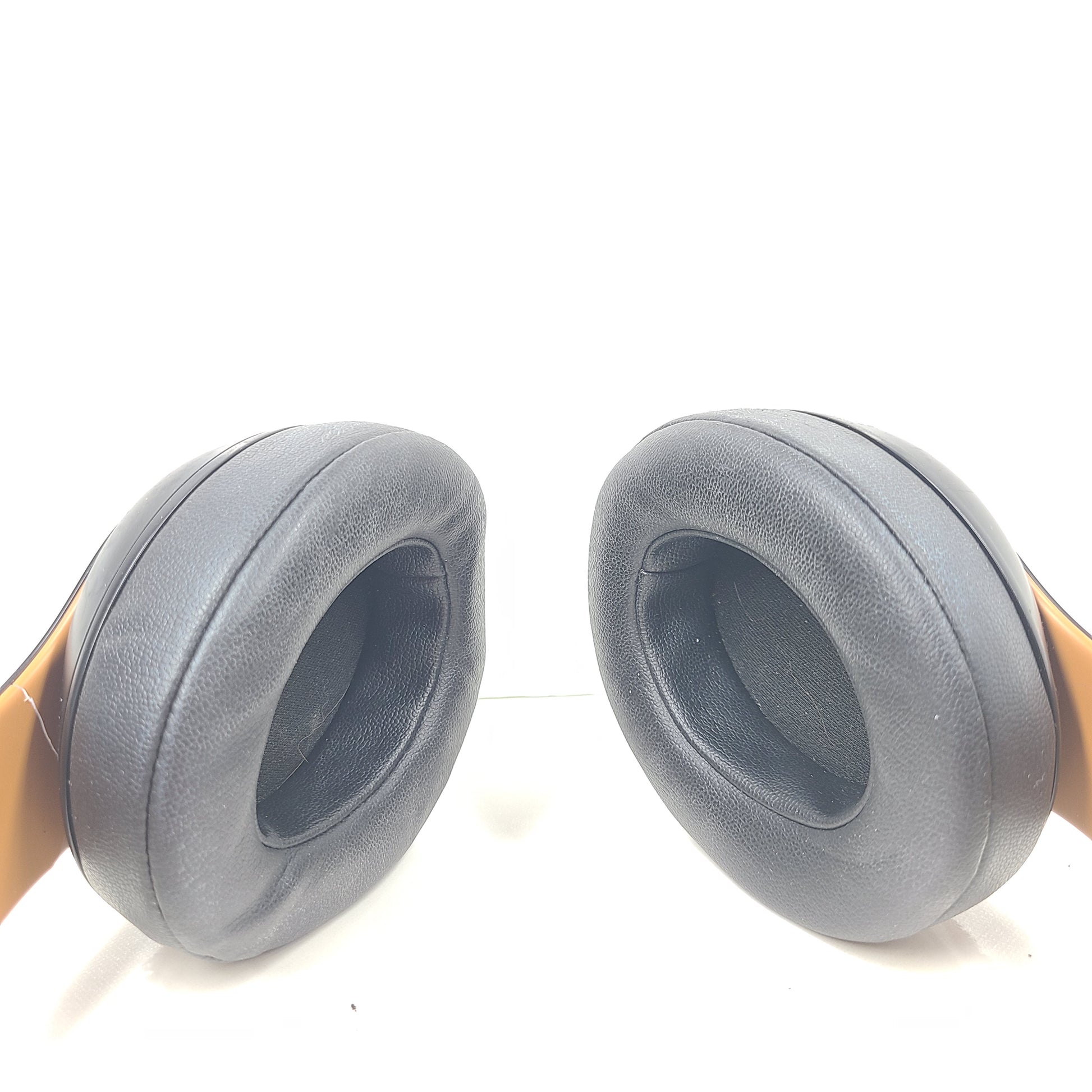 A pair of black and gold Beats Wireless Over-Ear Headphones