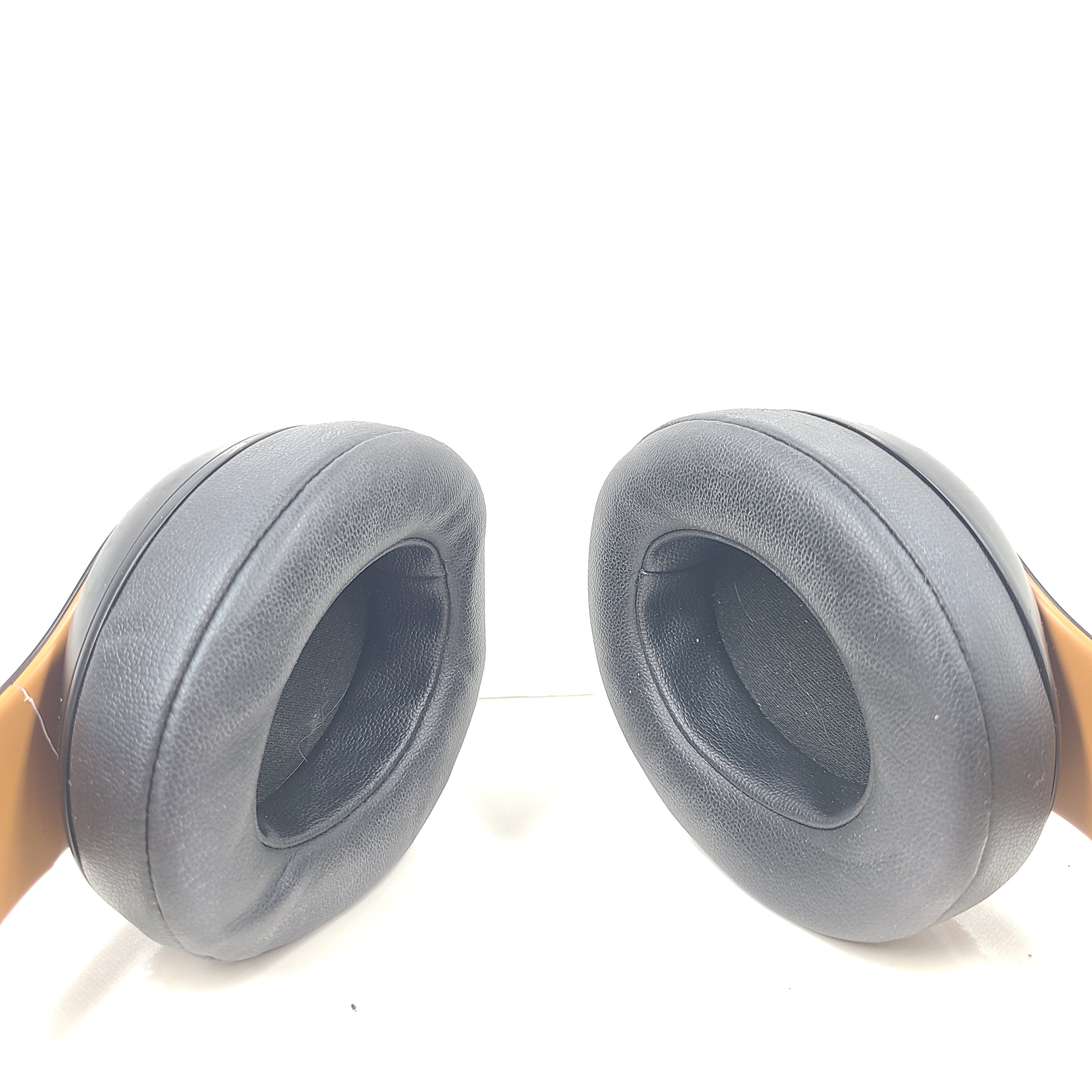 A pair of black and gold Beats Wireless Over-Ear Headphones