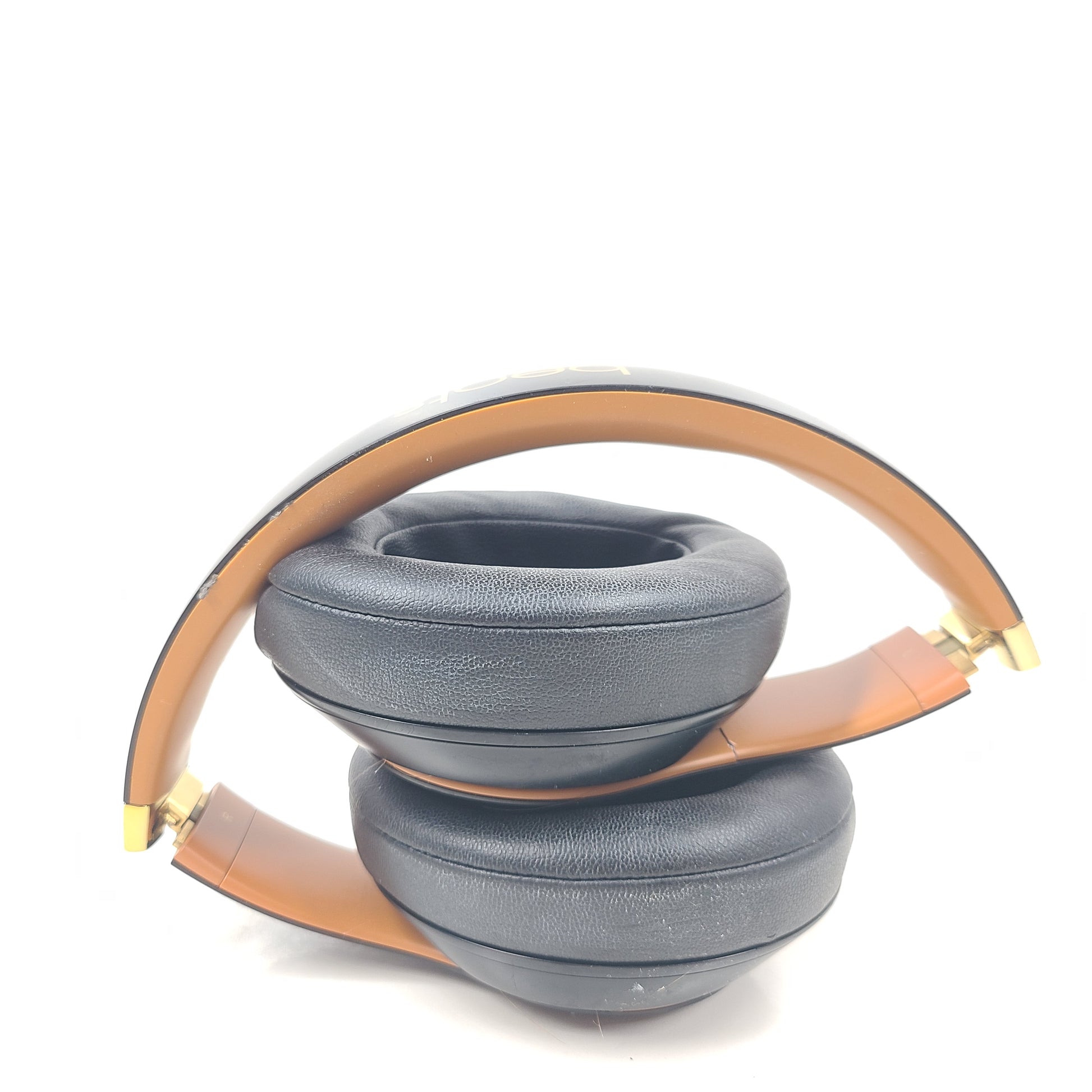 A pair of black and gold Beats Wireless Over-Ear Headphones