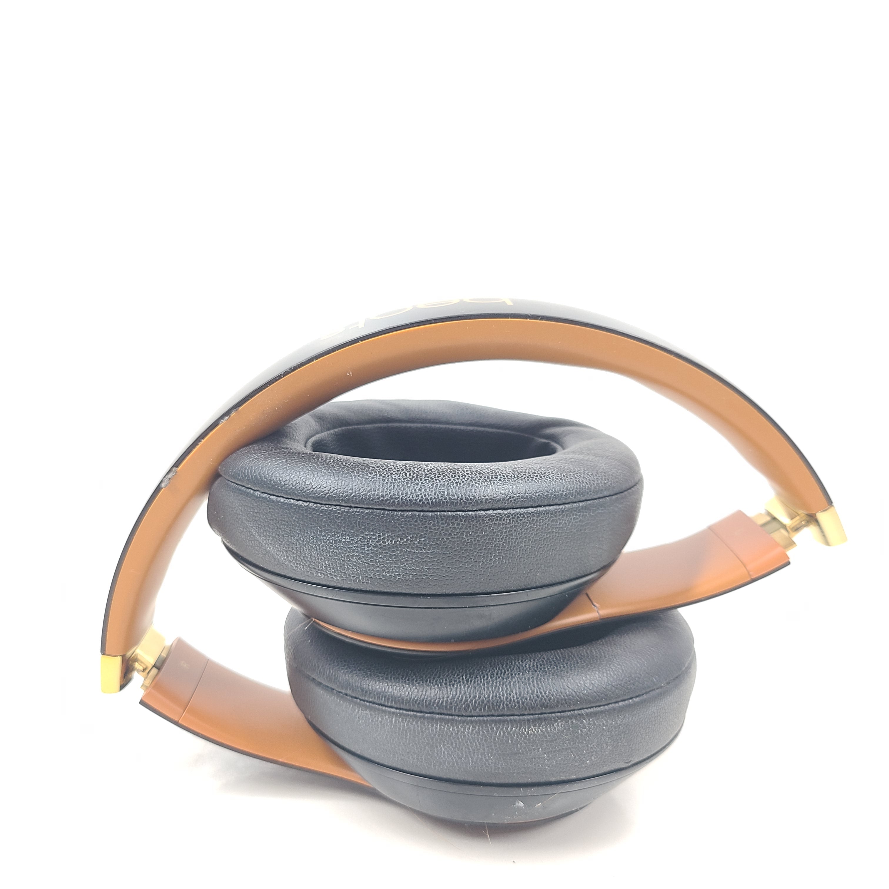 A pair of black and gold Beats Wireless Over-Ear Headphones