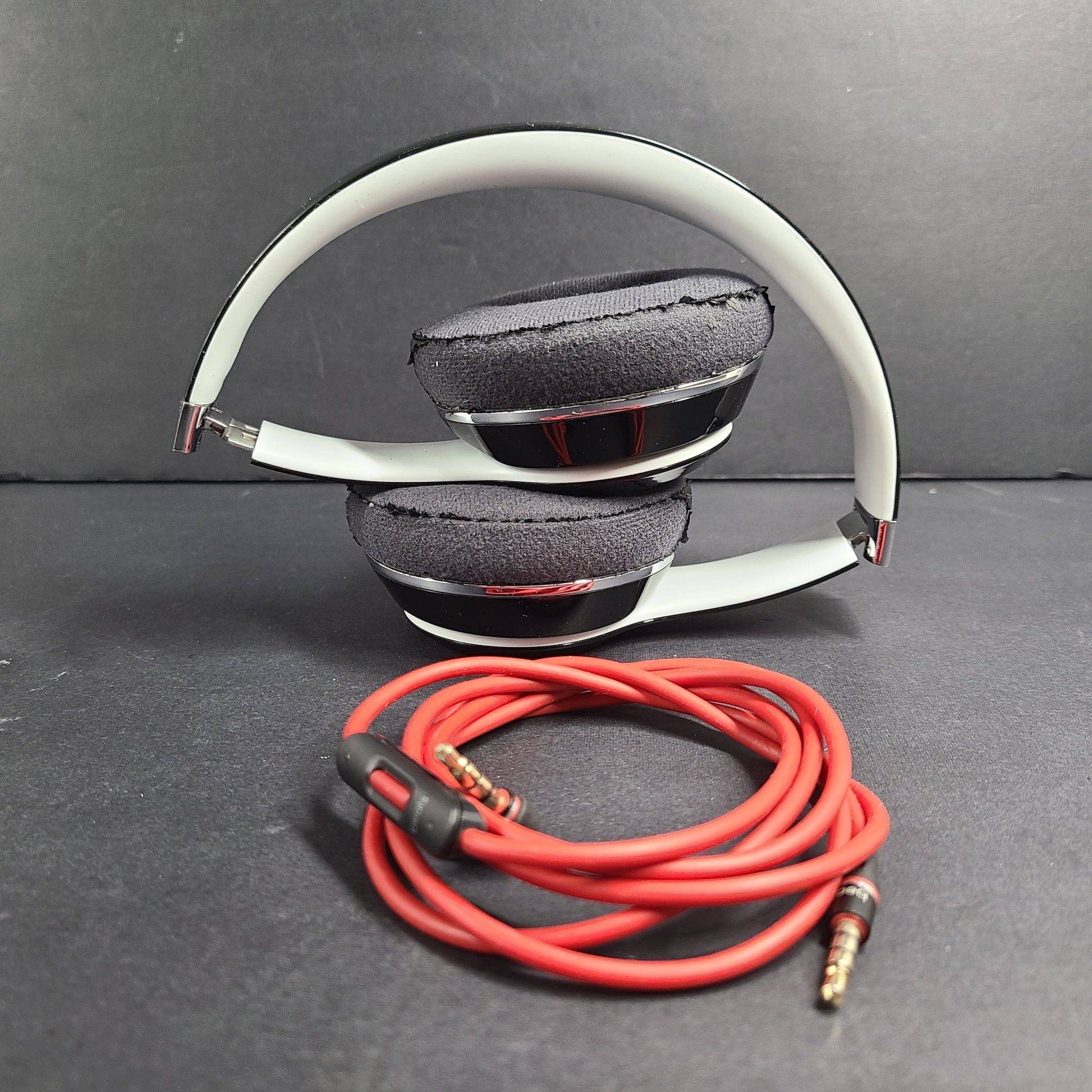 A pair of Beats Solo Wired Headphones with a red cable