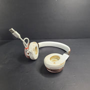 A stylish pair of rose gold wireless on-ear headphones offering premium sound and long-lasting comfort