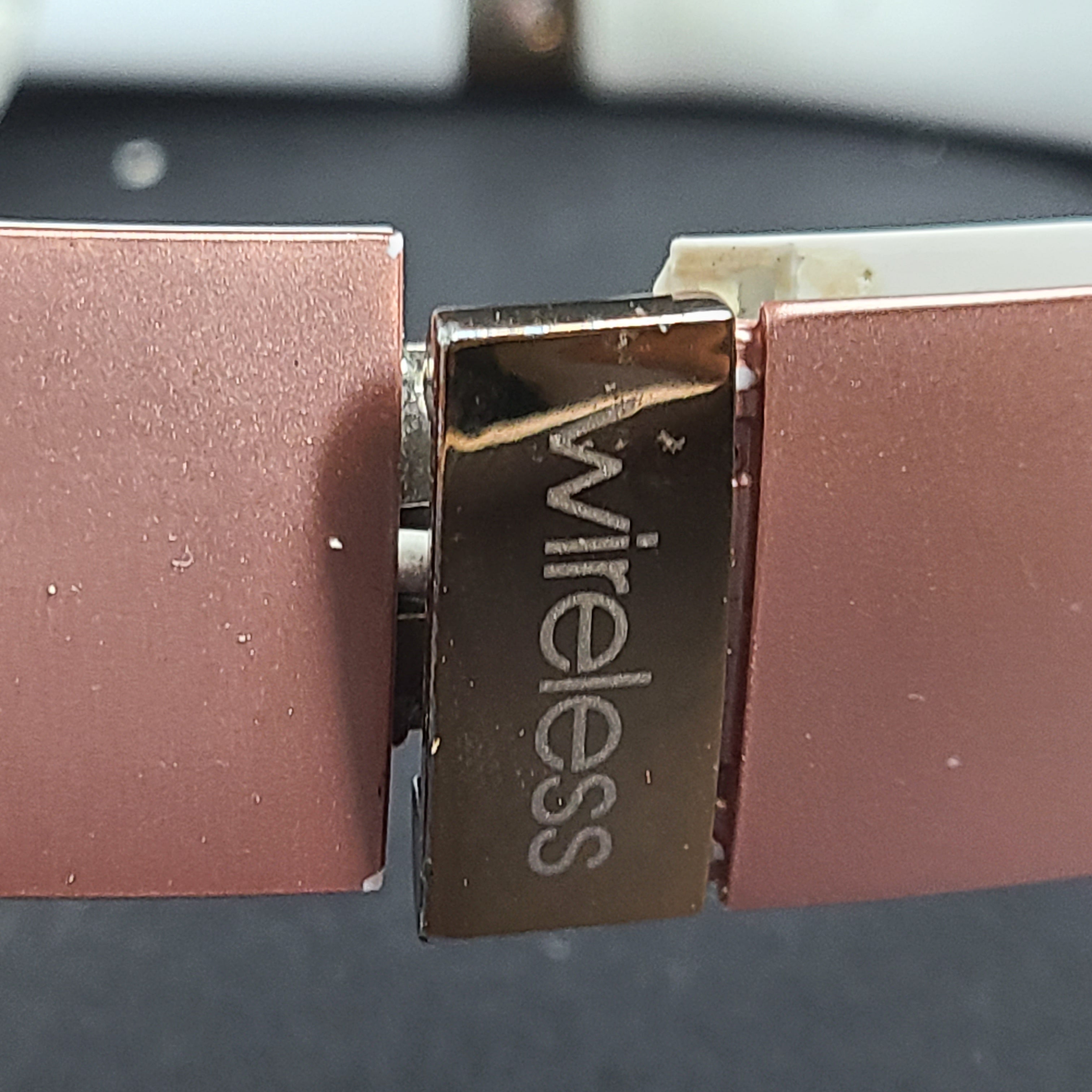 A stylish pair of rose gold wireless on-ear headphones offering premium sound and long-lasting comfort
