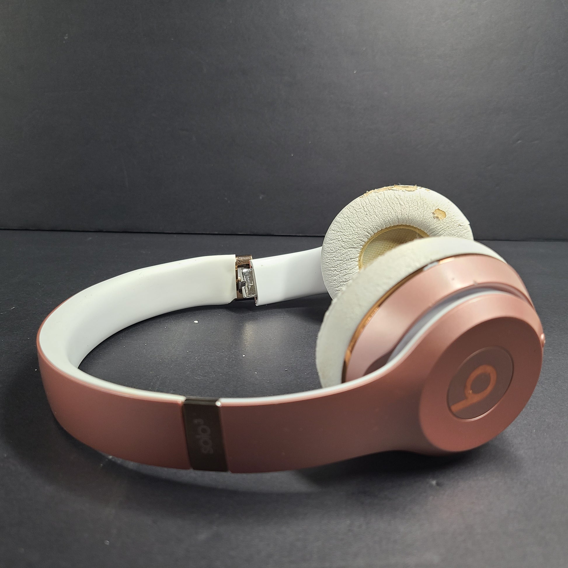 A stylish pair of rose gold wireless on-ear headphones offering premium sound and long-lasting comfort