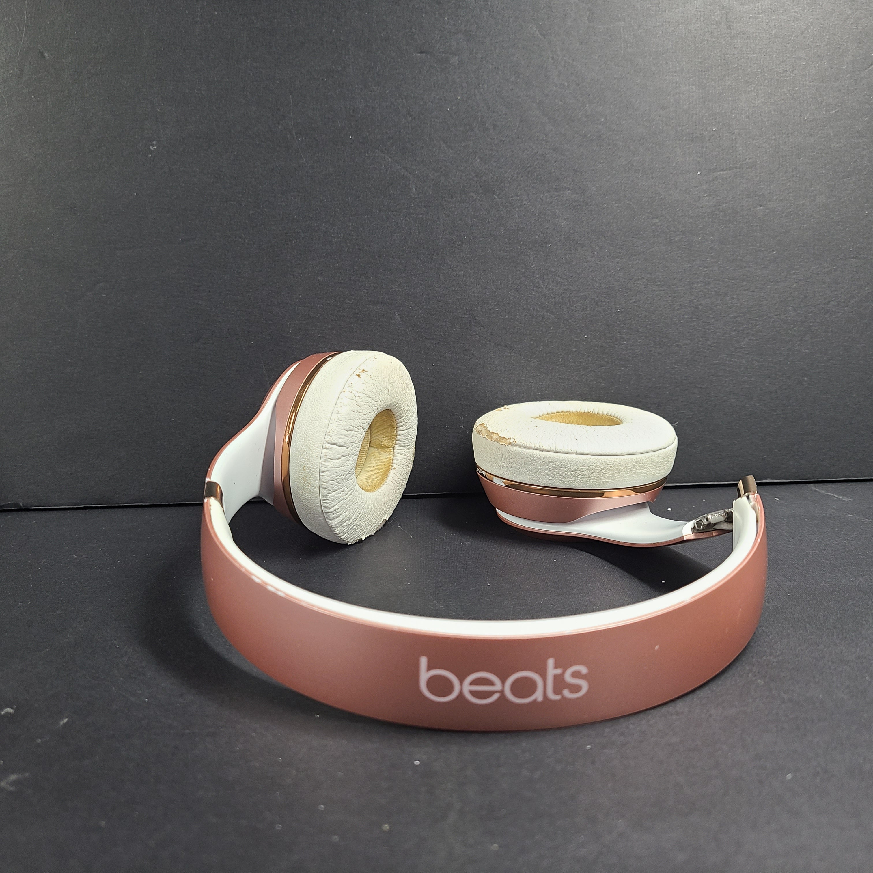 A stylish pair of rose gold wireless on-ear headphones offering premium sound and long-lasting comfort