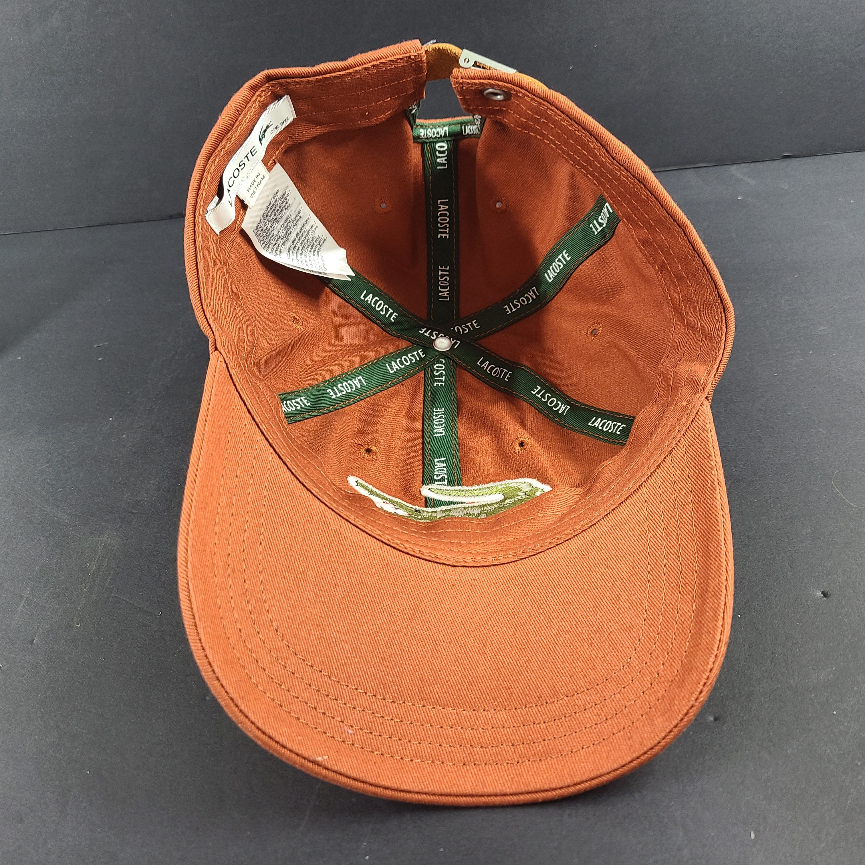 A stylish Lacoste baseball cap in brown color.