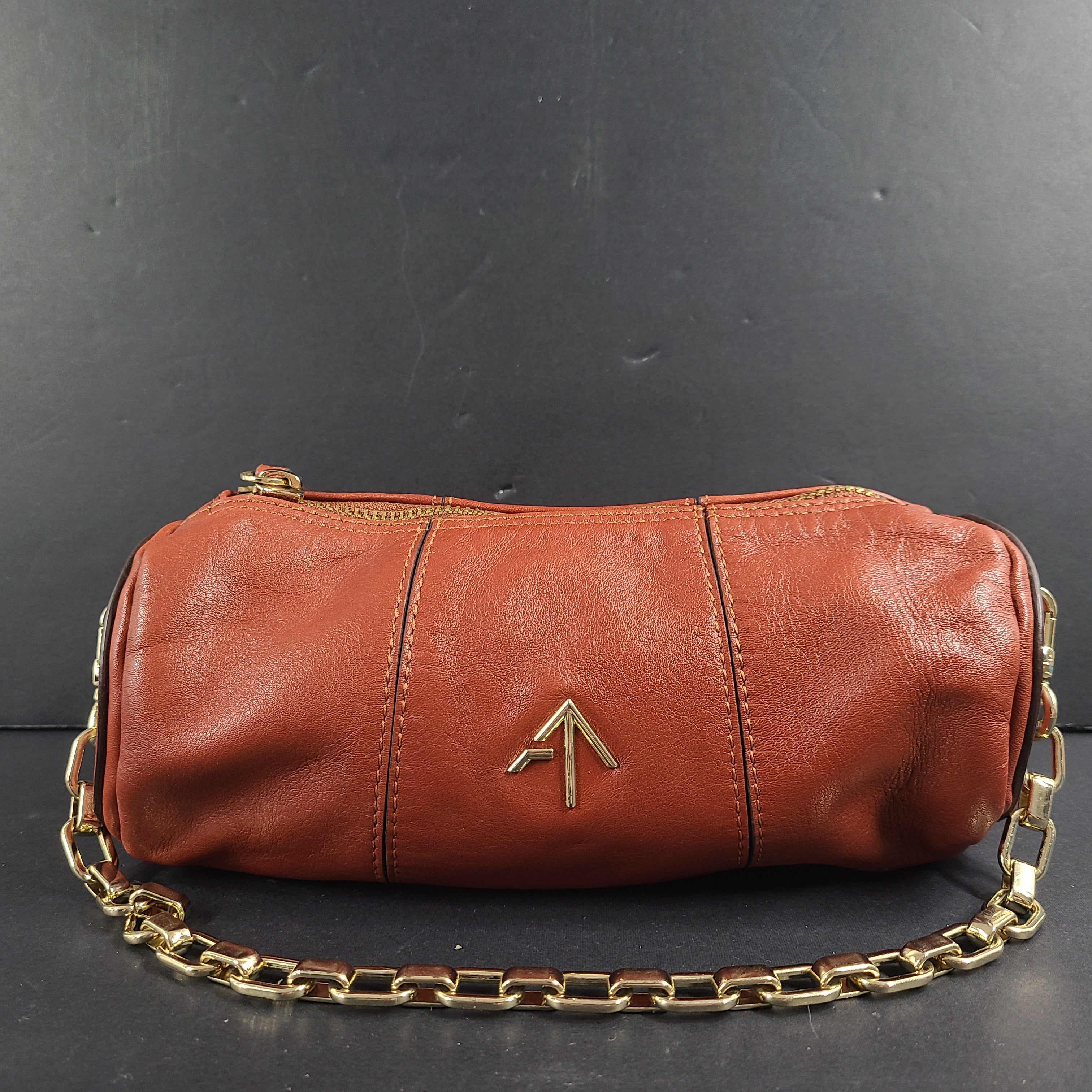 A stylish brown leather handbag with chain strap