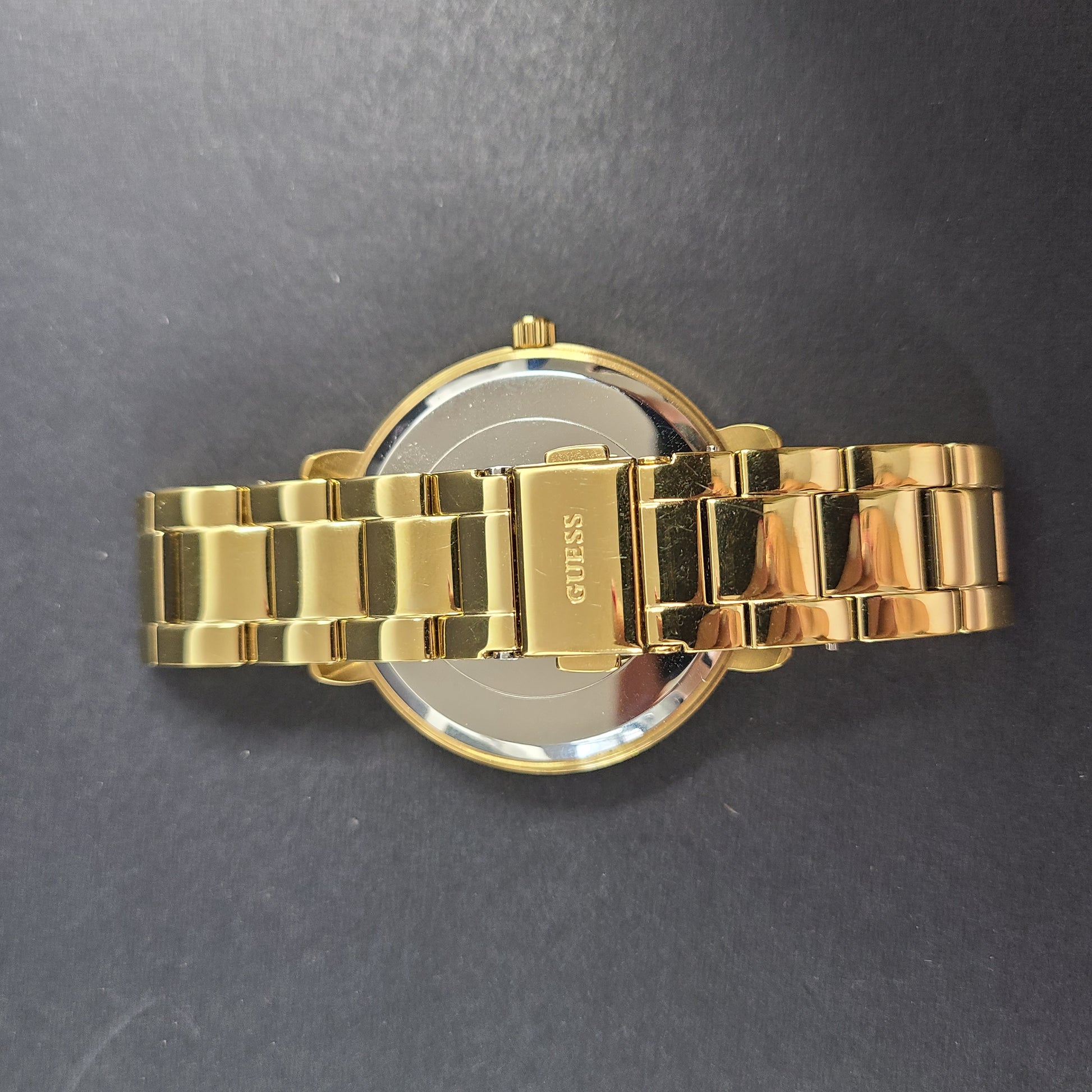 A stylish Guess rose gold-tone stainless steel women's watch.