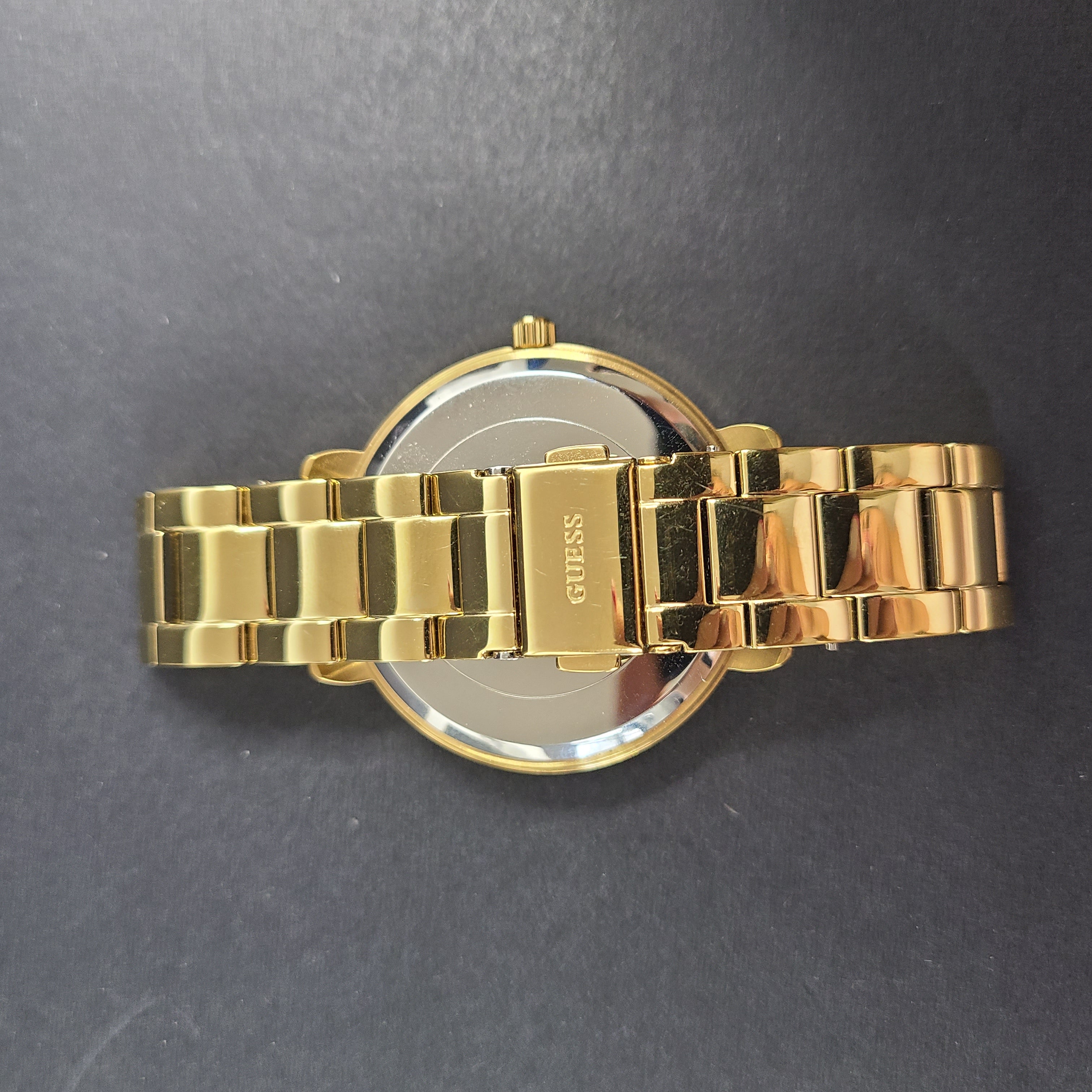 A stylish Guess rose gold-tone stainless steel women's watch.