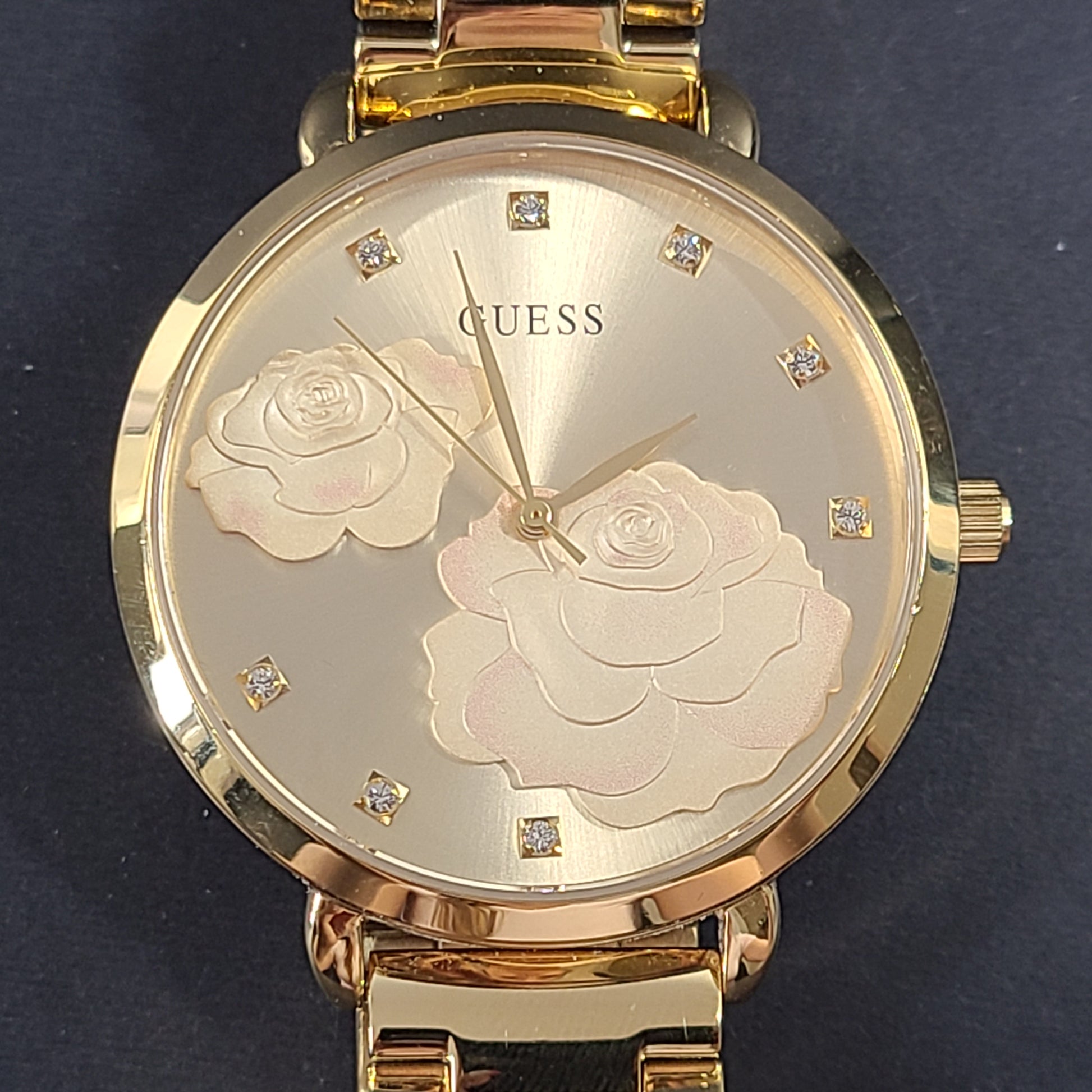 A stylish Guess rose gold-tone stainless steel women's watch.