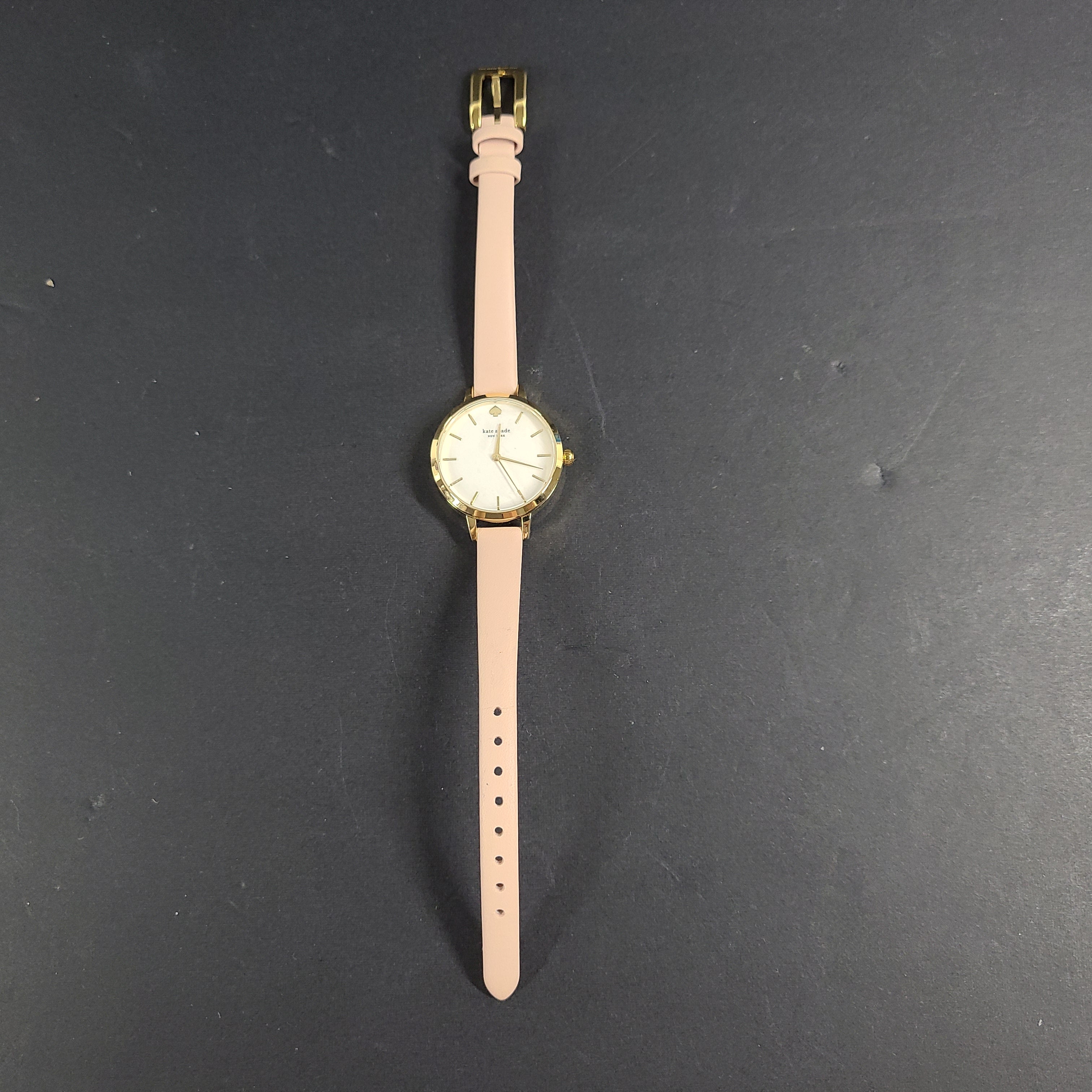 A stylish Kate Spade New York women's watch in gold and pink