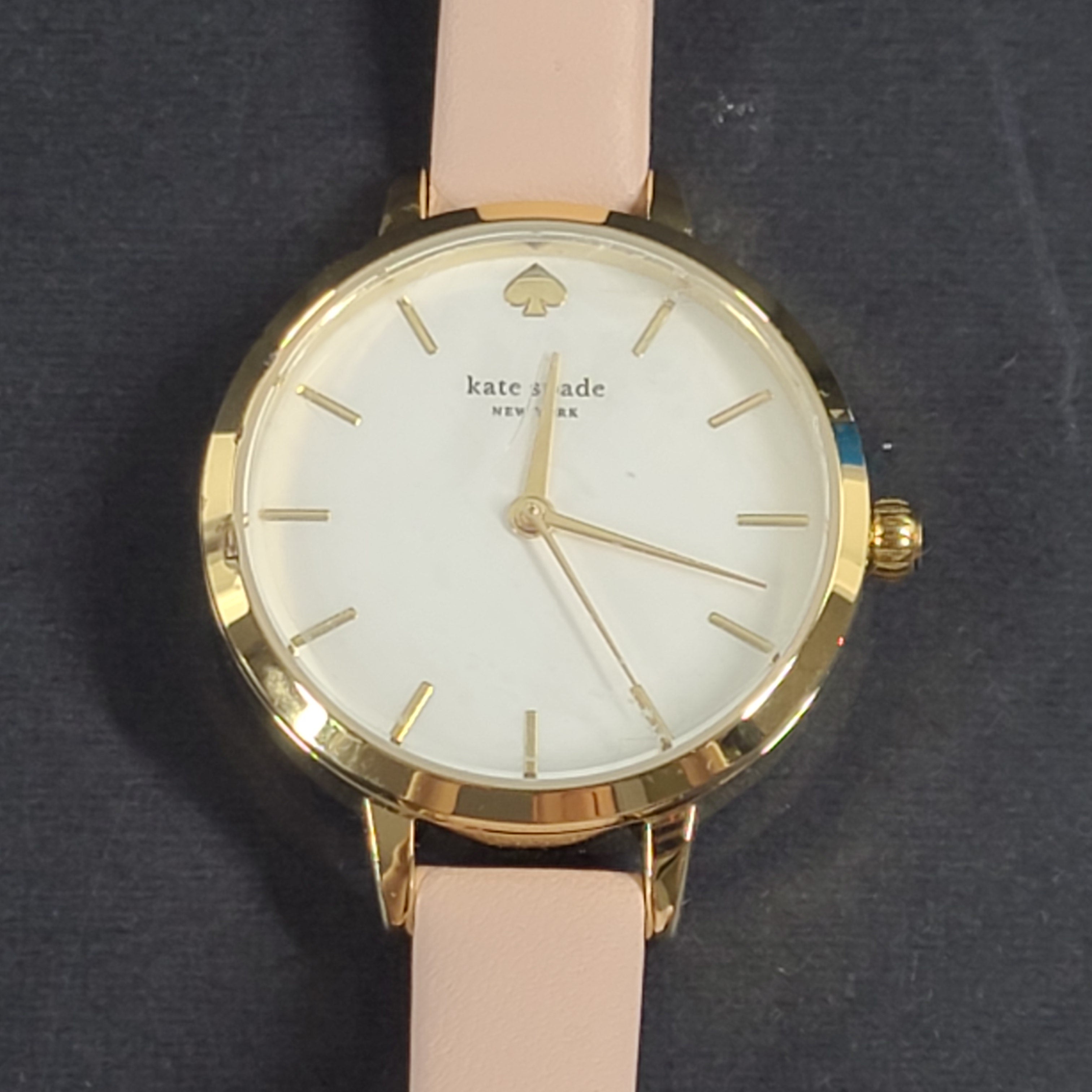 A stylish Kate Spade New York women's watch in gold and pink