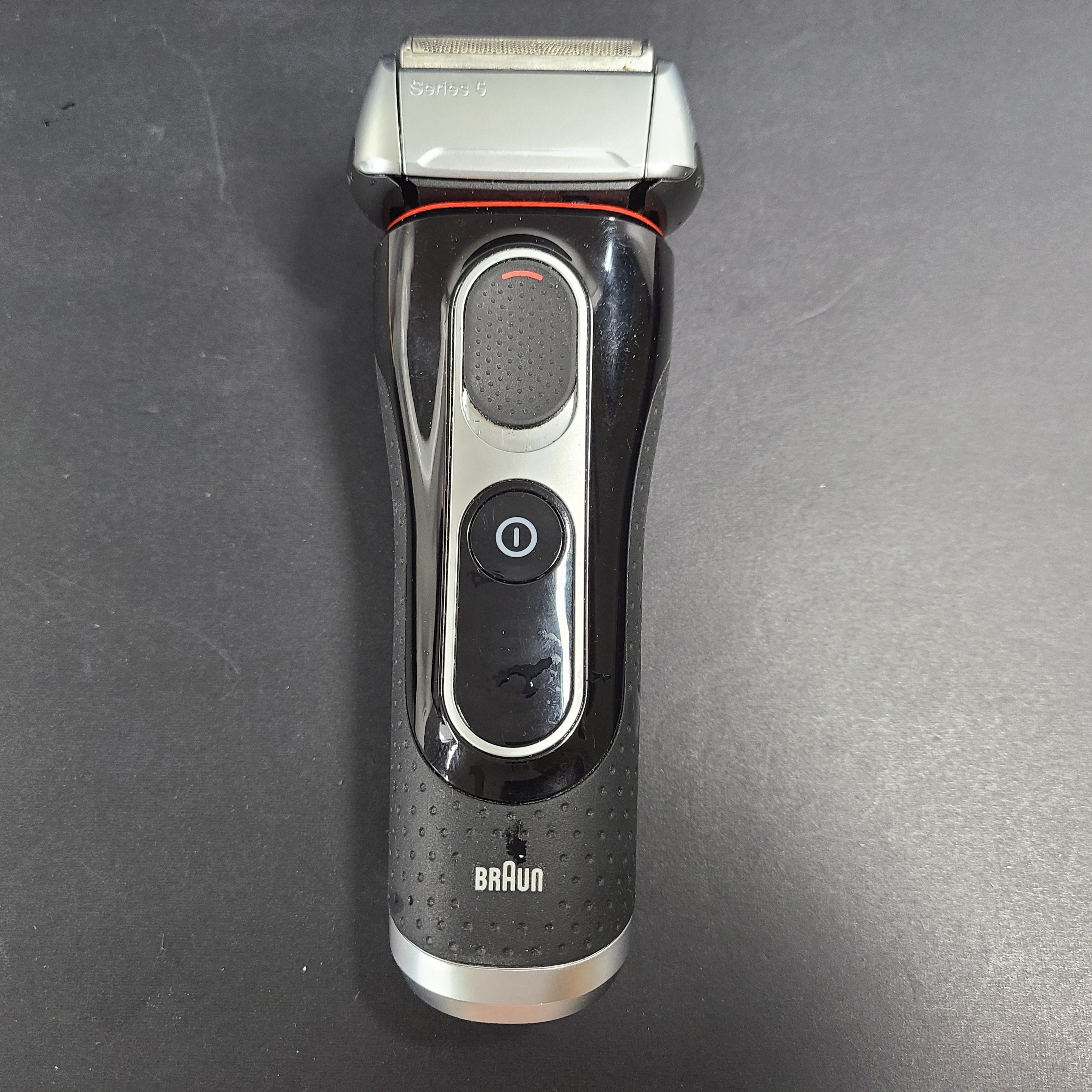 A Braun Series 5 Electric Shaver in pre-owned condition with charging cord.
